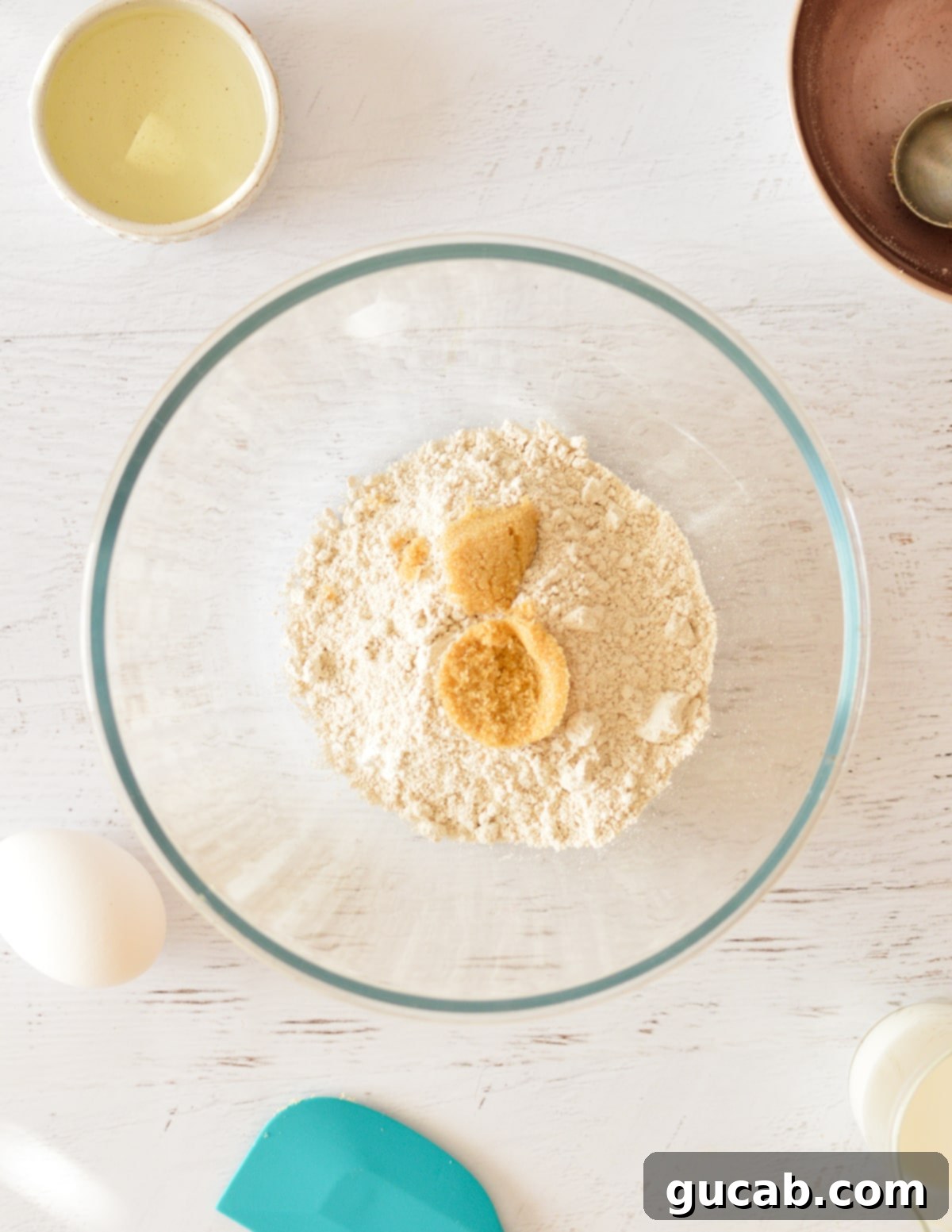 Light and Fluffy Oat Flour Pancakes 4 A bowl containing a mix of oat flour and brown sugar, representing the dry ingredients.