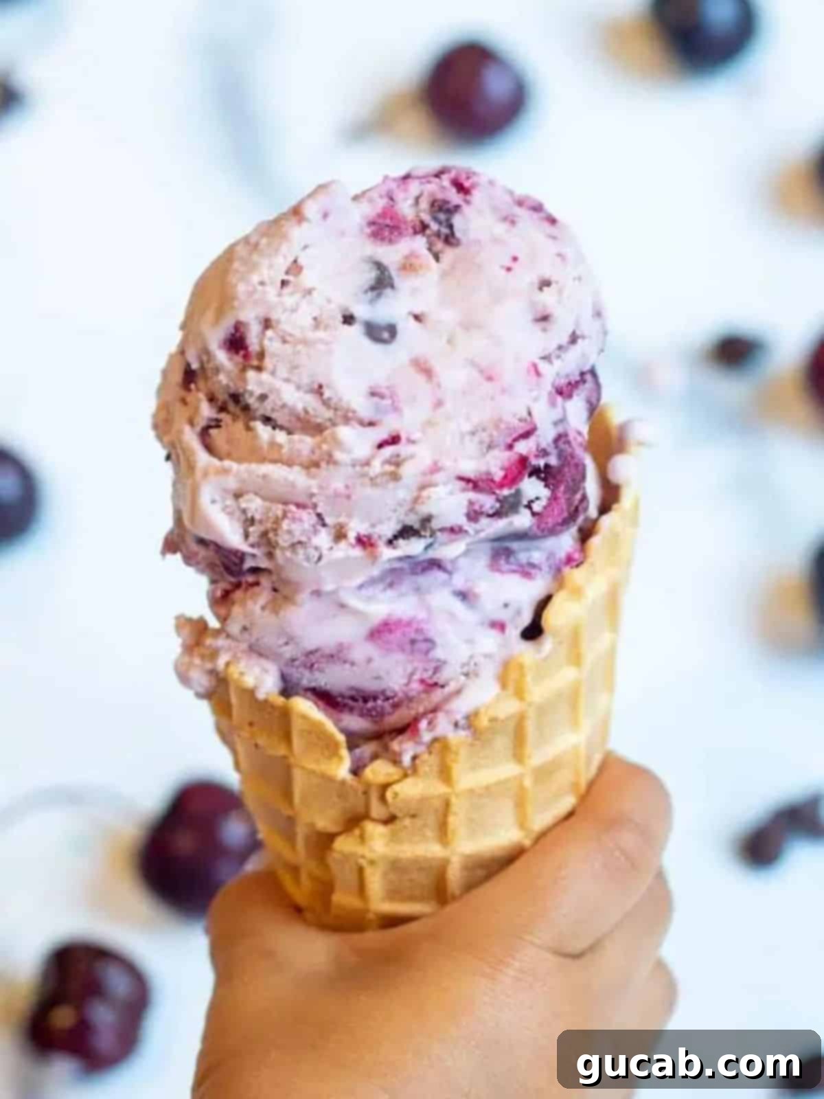 13 Nostalgic Ice Cream Maker Recipes 5 cherry ice cream on a cone.