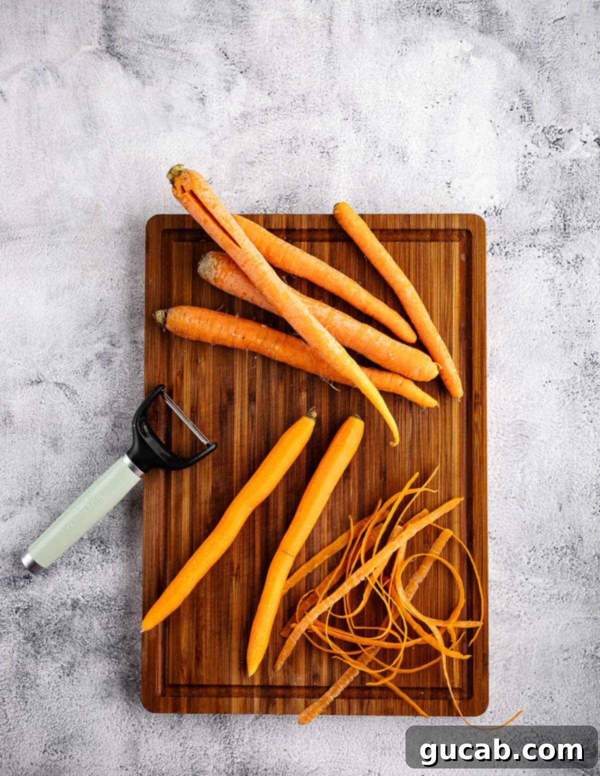 Maple-Glazed Roasted Carrots 5 peeled carrots on a cutting board,