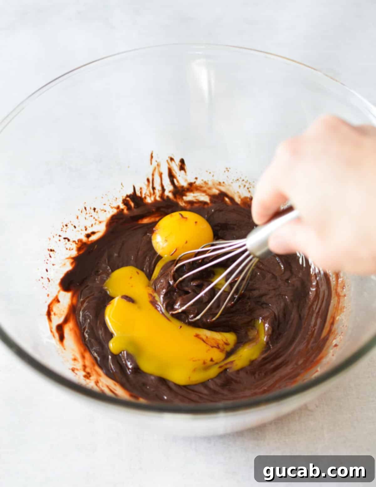 whisking egg yolks into melted chocolate. 