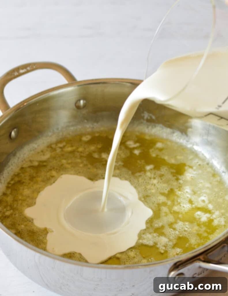 pouring cream into butter in a skillet.