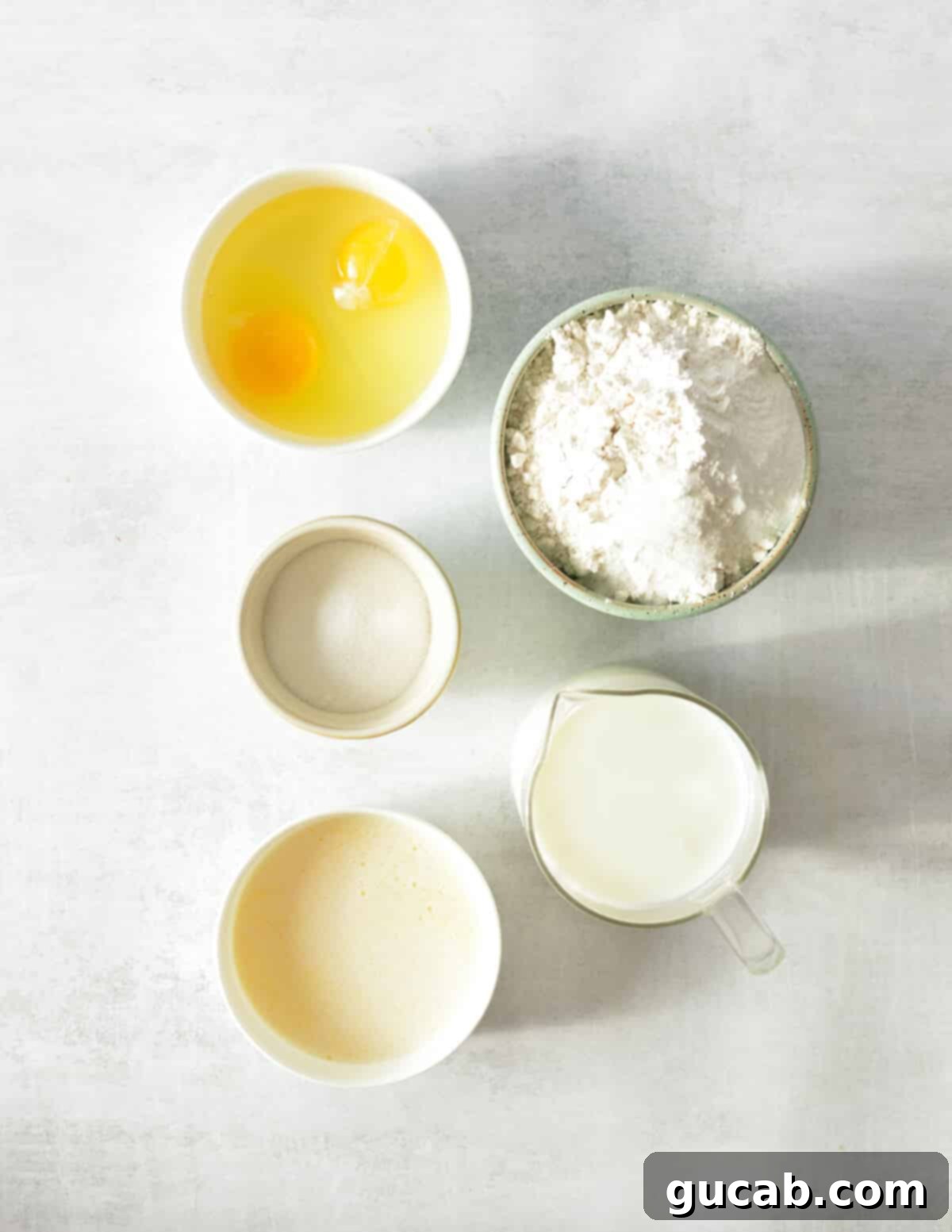 eggs, flour, sugar, buttermilk, melted butter, and leavening agents ready for Joanna Gaines' pancake recipe.