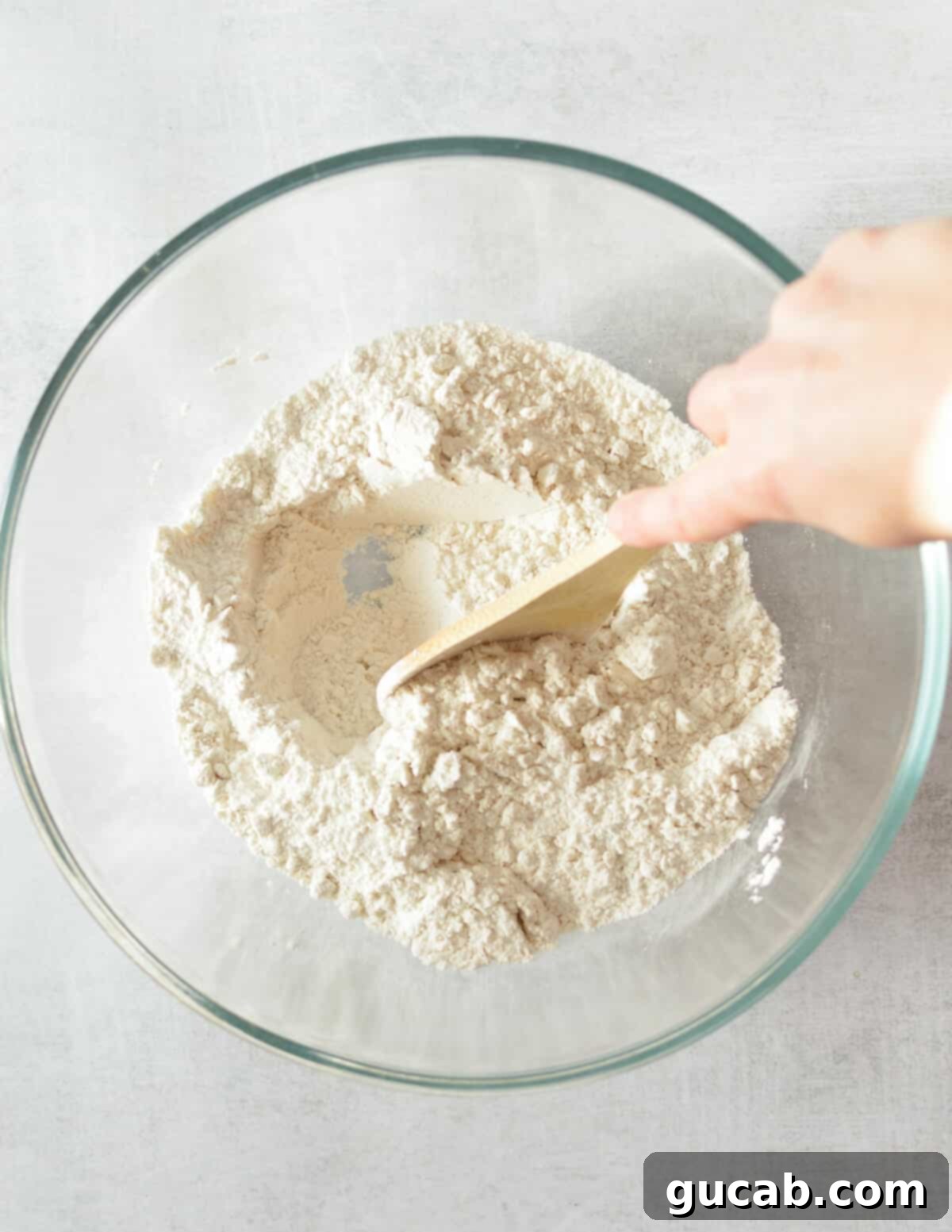a bowl of flour, sugar, baking powder, baking soda, and salt mixed together.