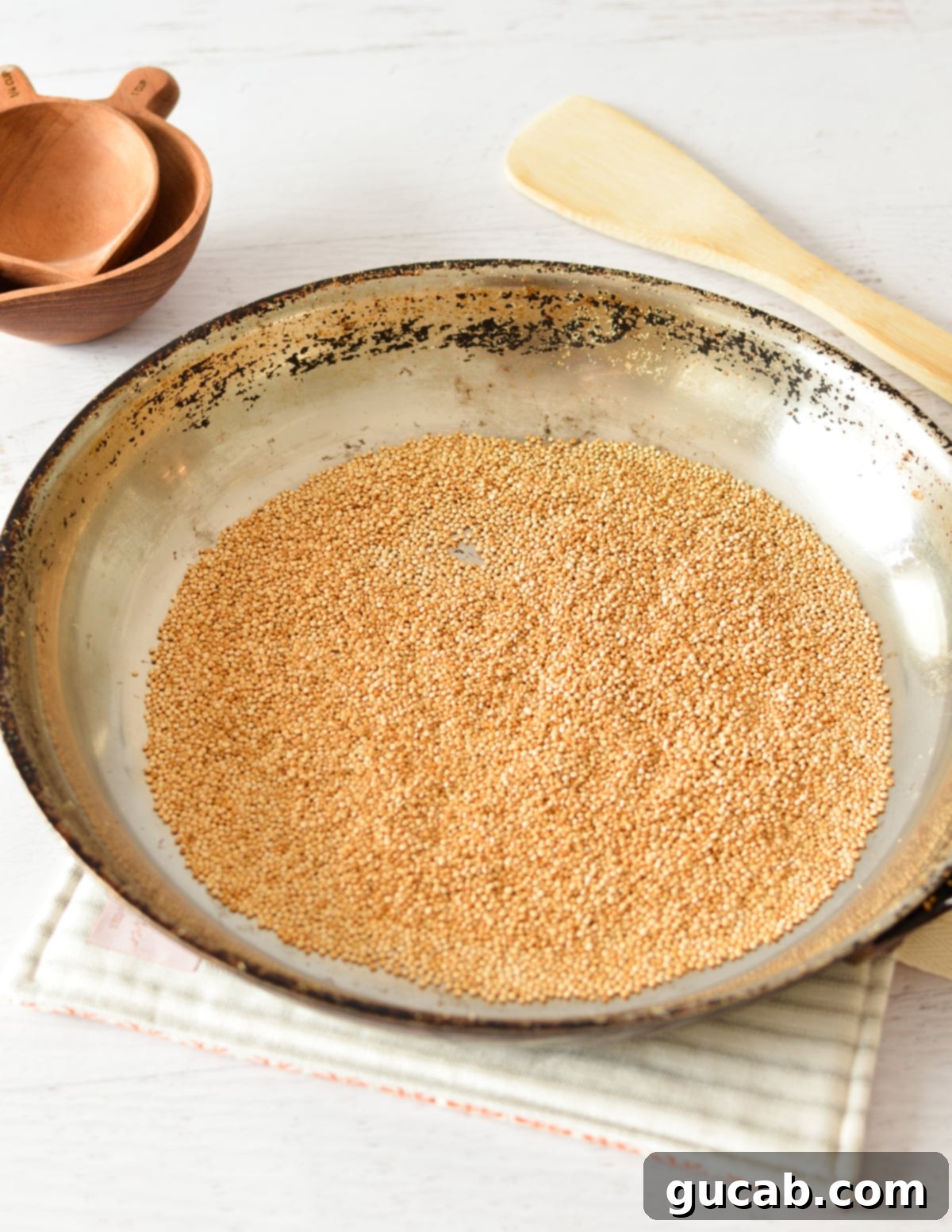 A skillet full of freshly popped and golden-brown quinoa, emitting a delicious aroma.
