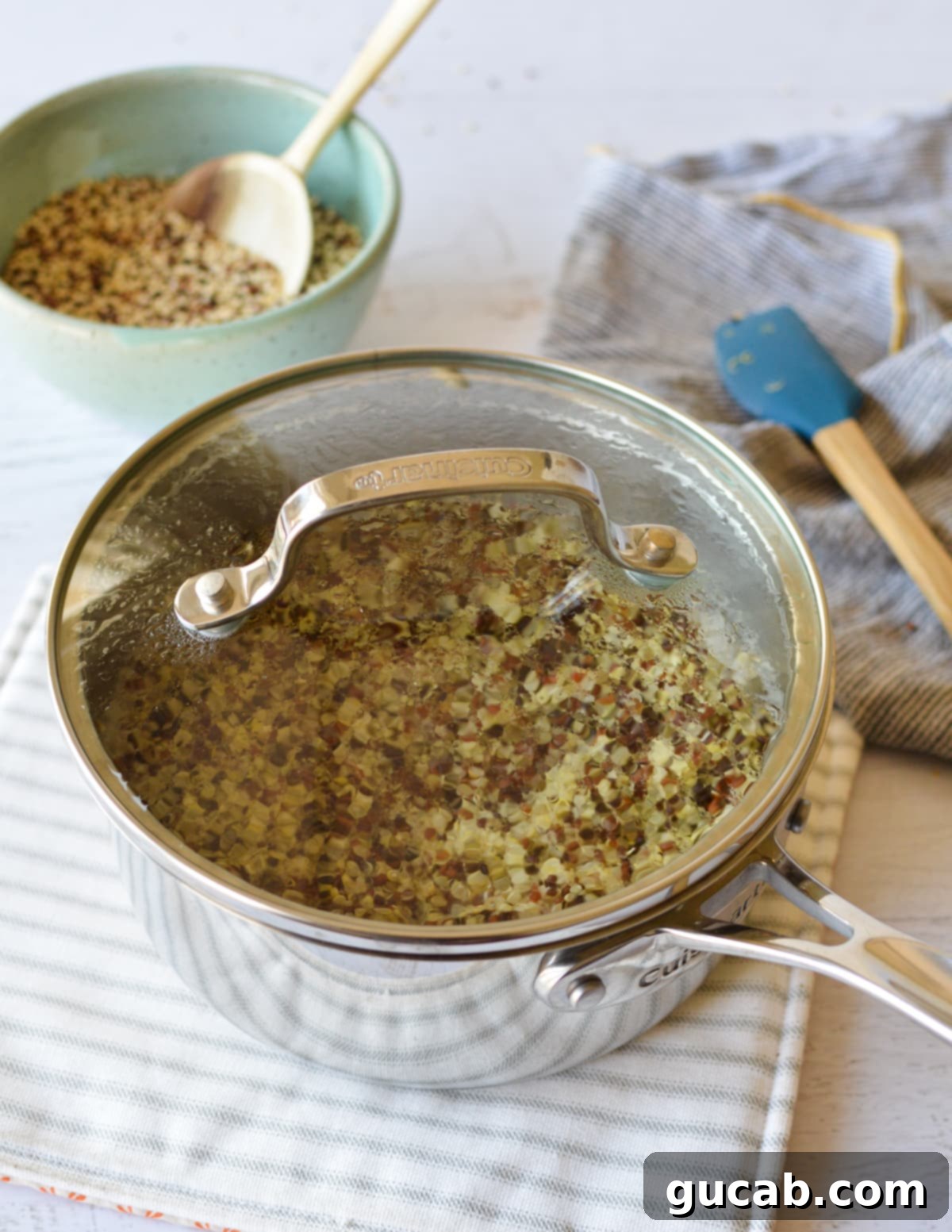 Perfect Tri-Color Quinoa Every Time 5 cooked quinoa in a saucepan with a lid