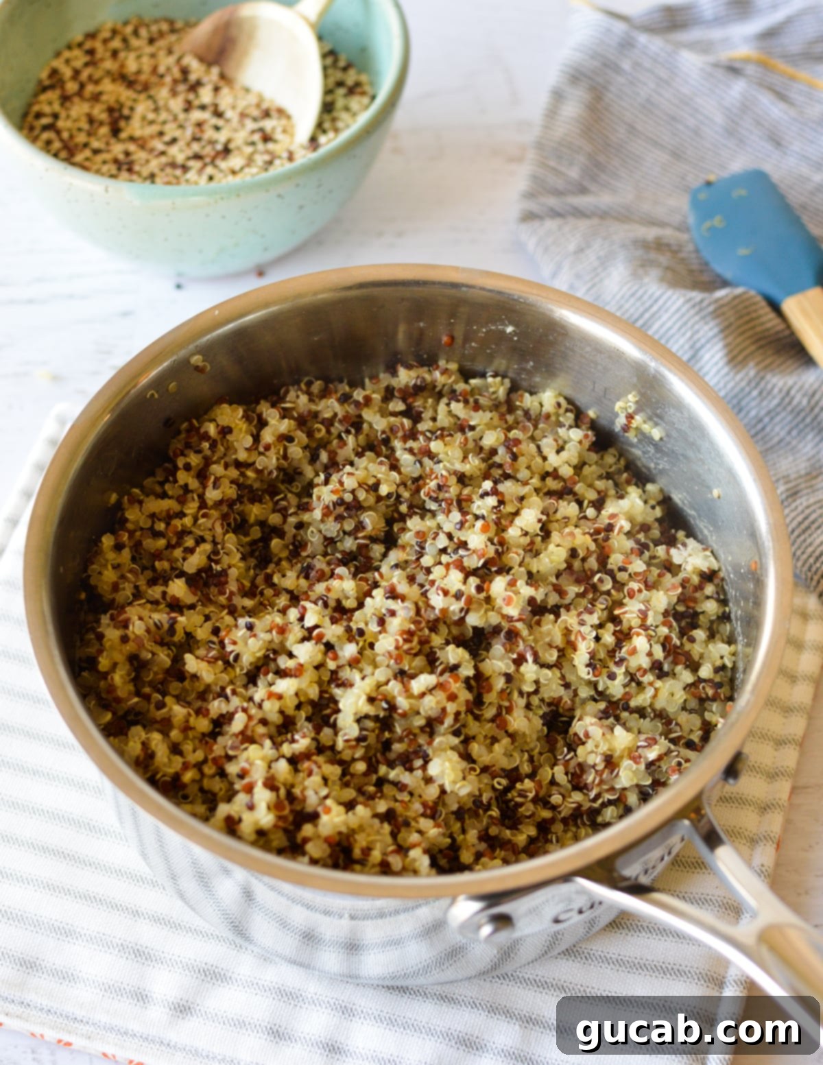 Perfect Tri-Color Quinoa Every Time 6 a saucepan full of cooked quinoa.
