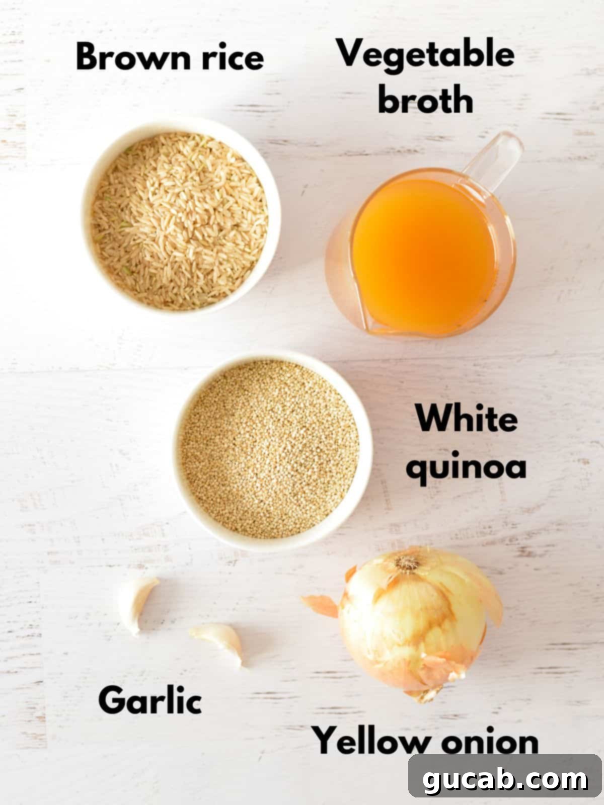 Easy Brown Rice and Quinoa 3 Raw ingredients for brown rice and quinoa: brown rice, vegetable broth, white quinoa, fresh garlic cloves, and a yellow onion.