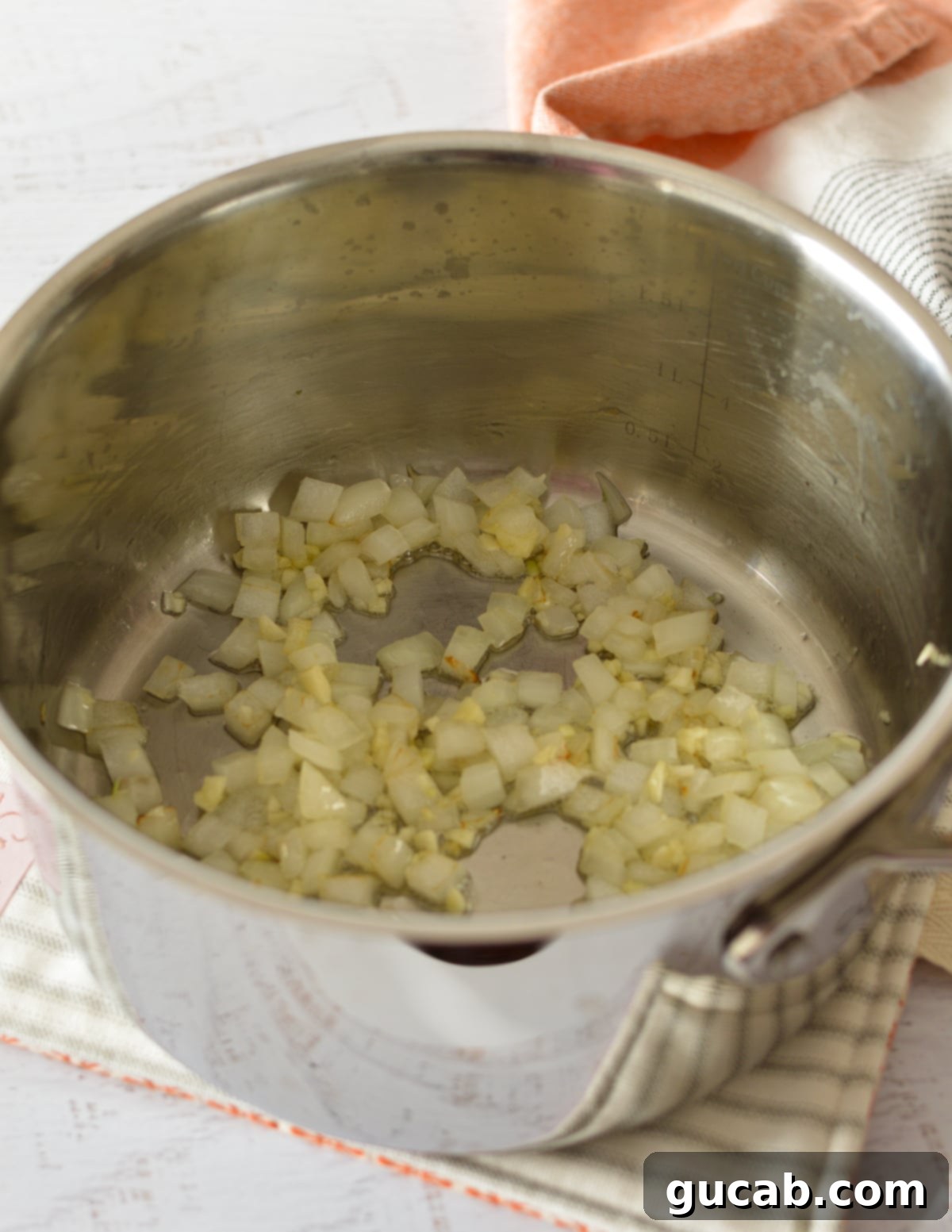 Sautéed onions and garlic in a saucepan, filling the kitchen with a warm aroma.