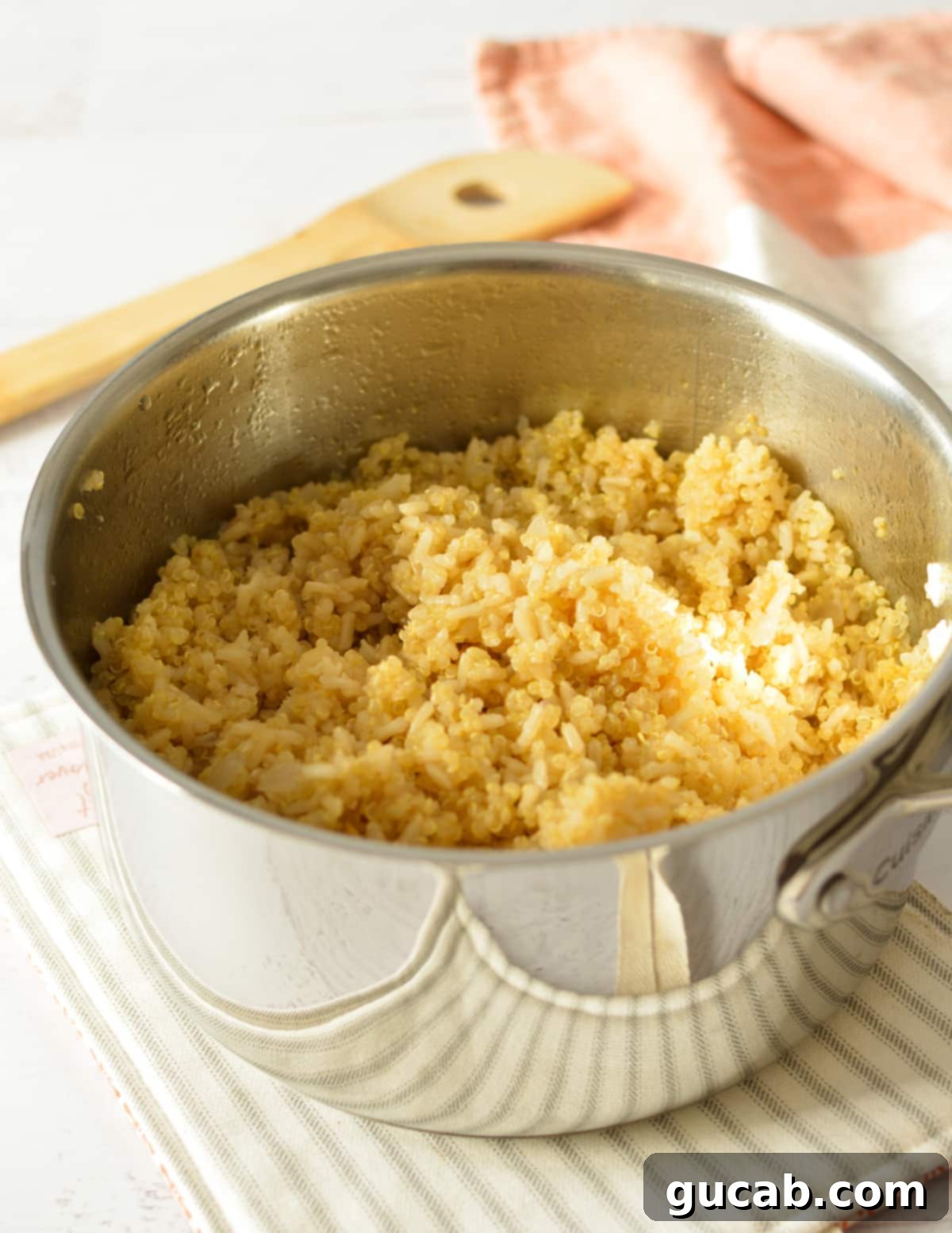 A serving of perfectly fluffy cooked brown rice and quinoa in a saucepan, ready for plating.