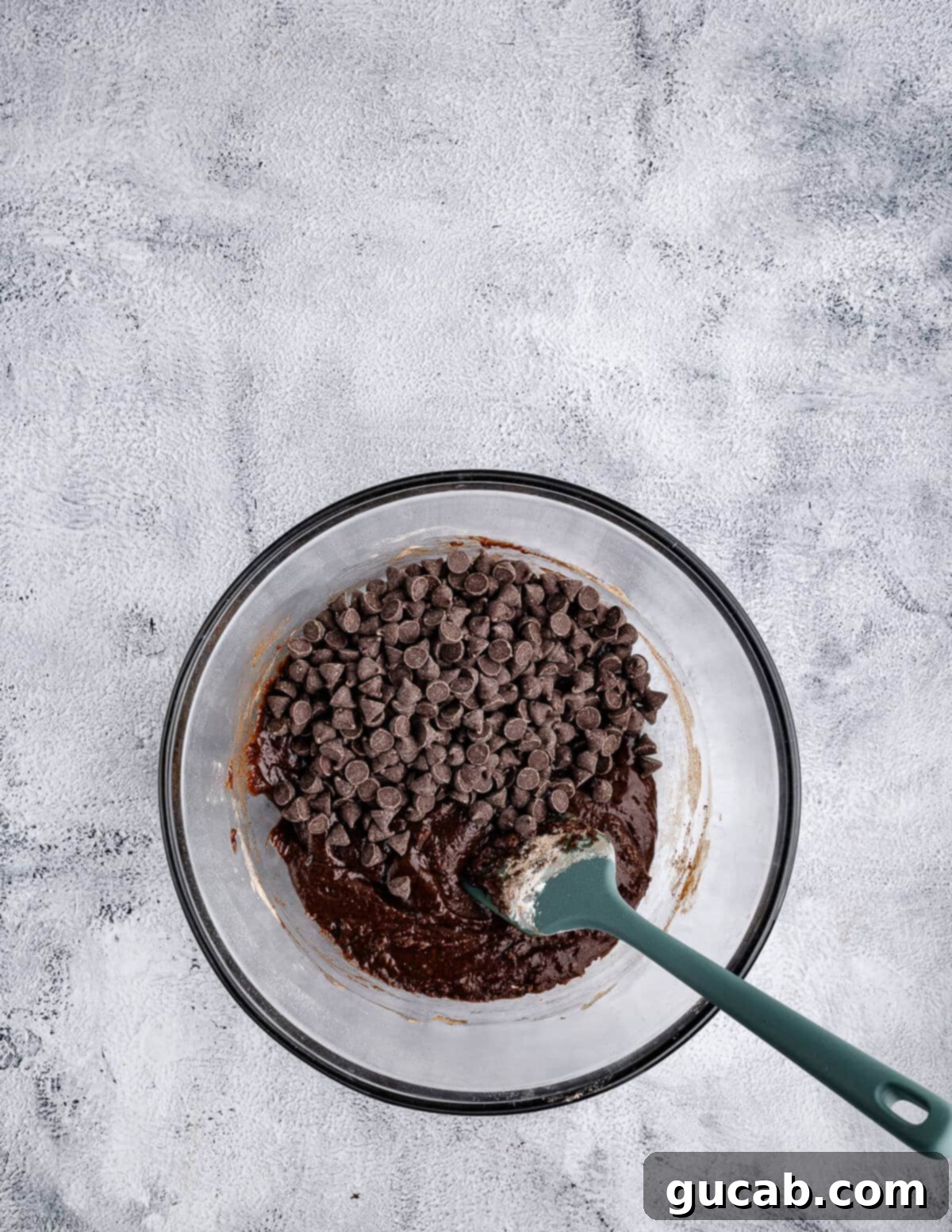 Decadent Gluten-Free Double Chocolate Delights 9 A bowl of chocolate cookie dough with a generous amount of semisweet chocolate chips mixed in.