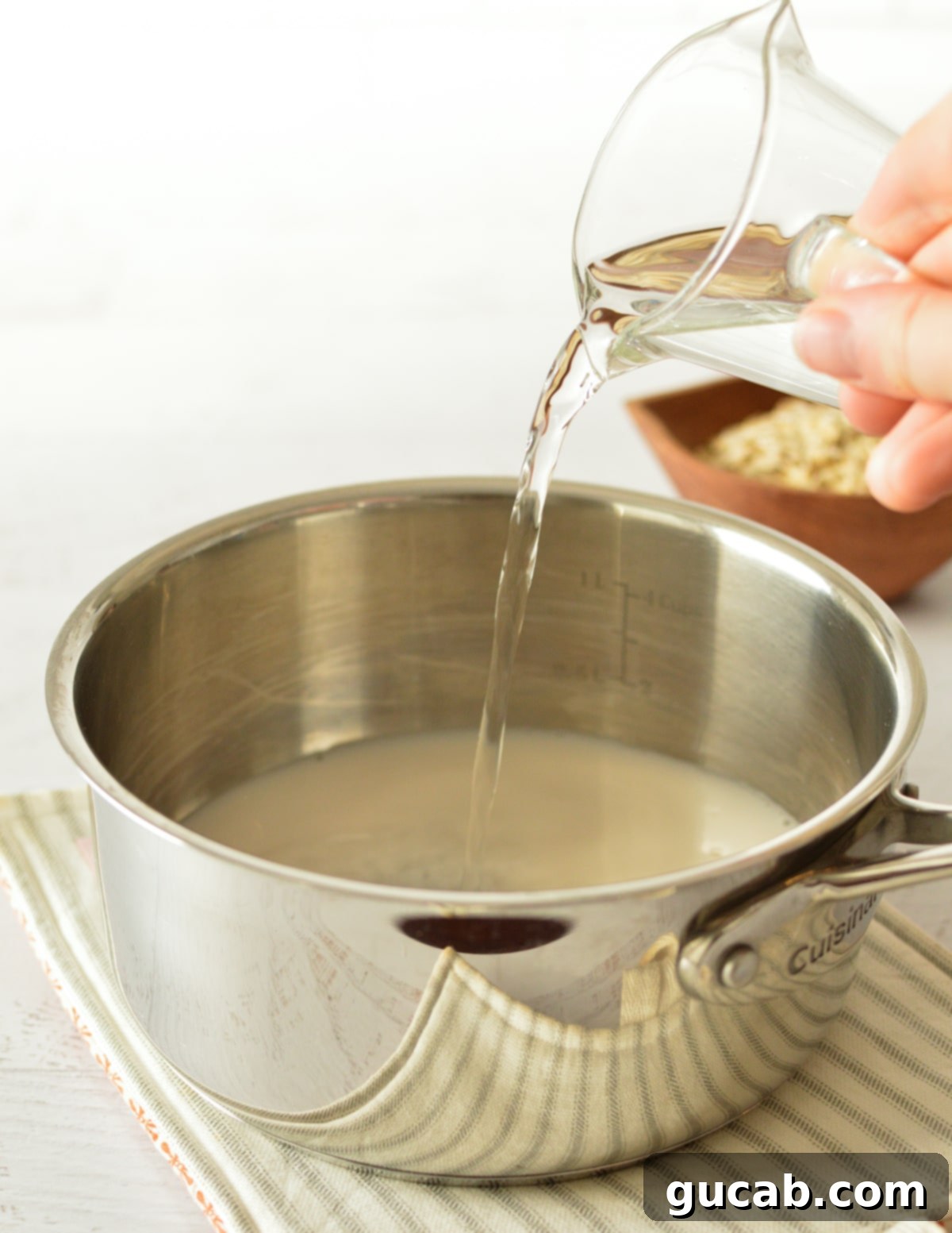 pouring water into a saucepan. 