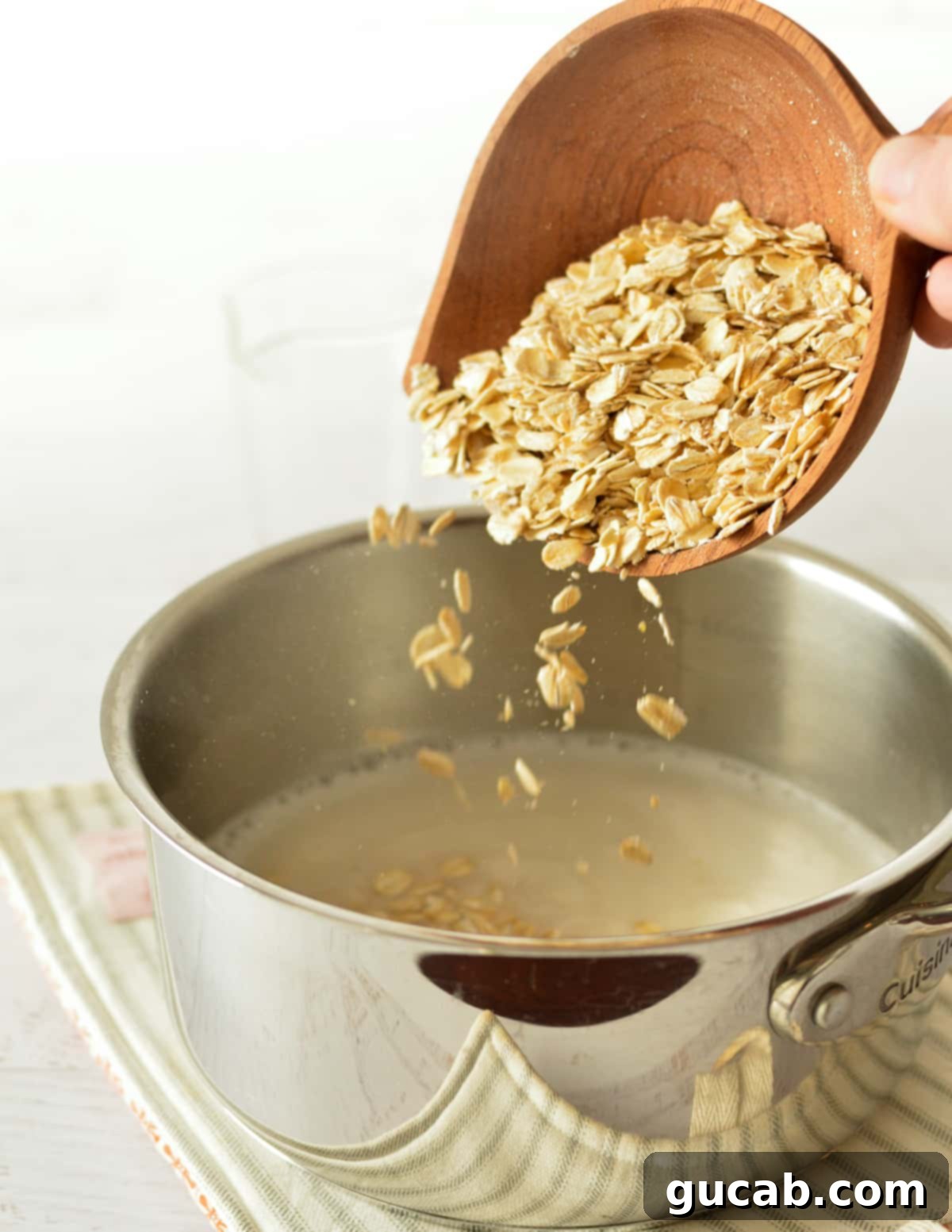 pouring oats into a saucepan with milk.