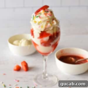 Summer Swirl Indulgence 14 A beautifully presented strawberry ice cream sundae, glistening with homemade sauce and topped with whipped cream.