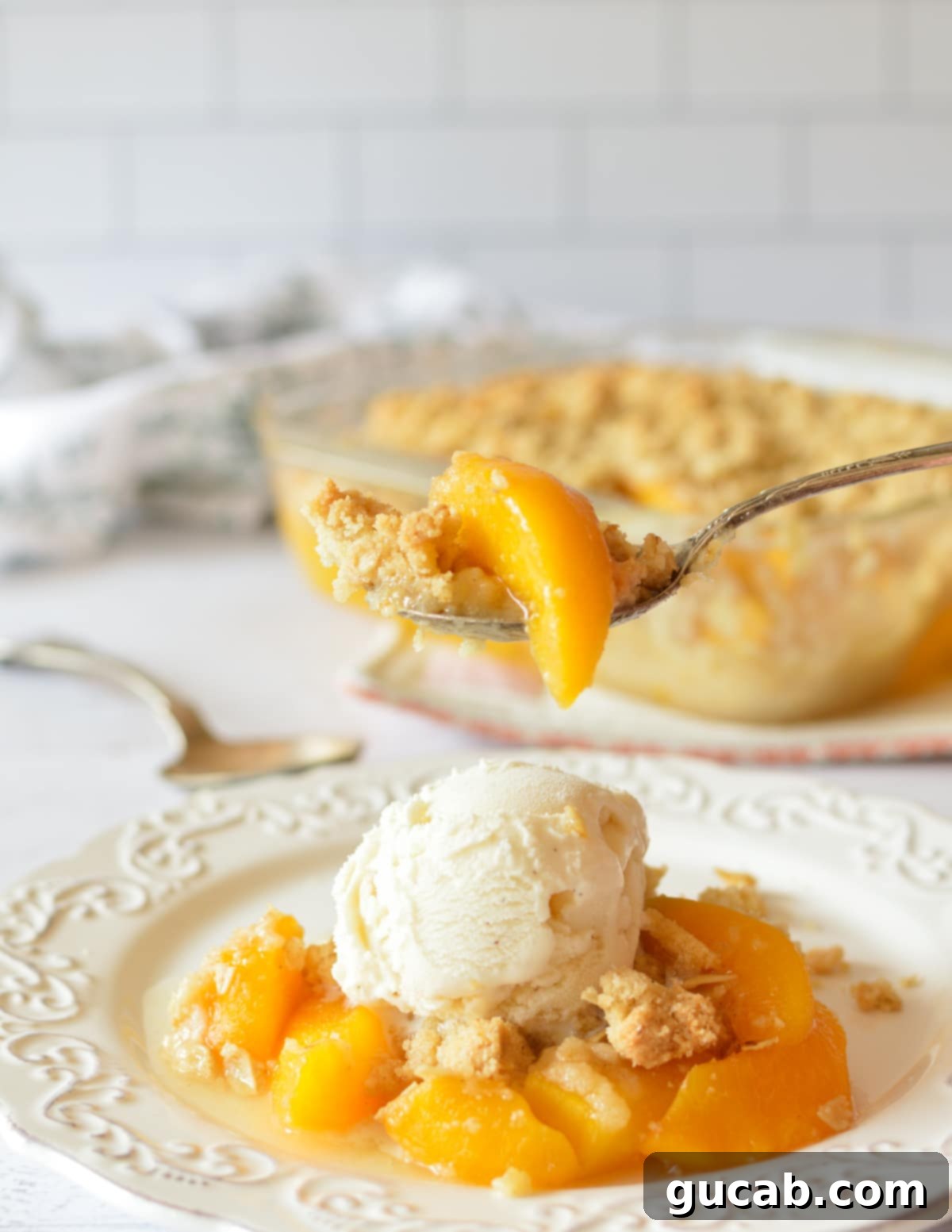 Pantry Peach Crisp Perfection 11 A forkful of peach crisp, showing the warm, bubbly peach filling and the crunchy oat topping.