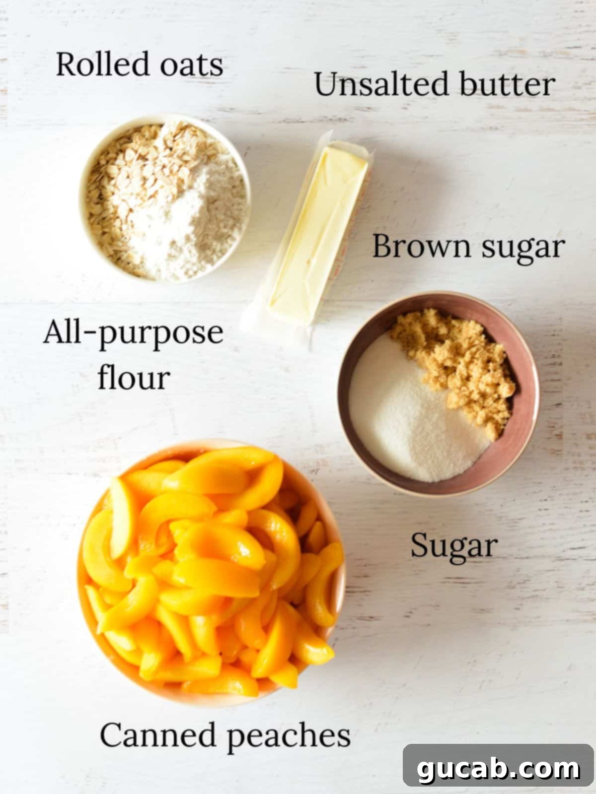 Pantry Peach Crisp Perfection 3 A flat lay of key ingredients for peach crisp: canned peaches, oats, flour, butter, sugar, and brown sugar.