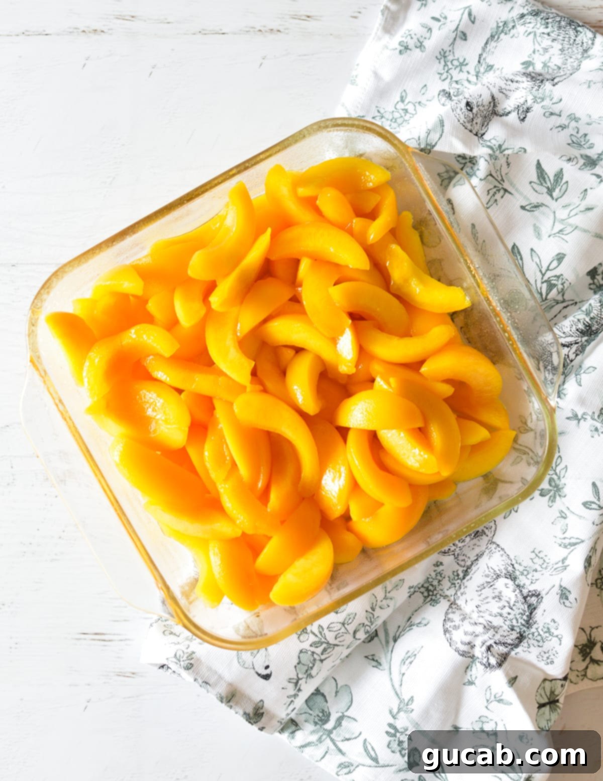 Pantry Peach Crisp Perfection 4 Drained canned peaches arranged in a glass baking dish, ready for the topping.