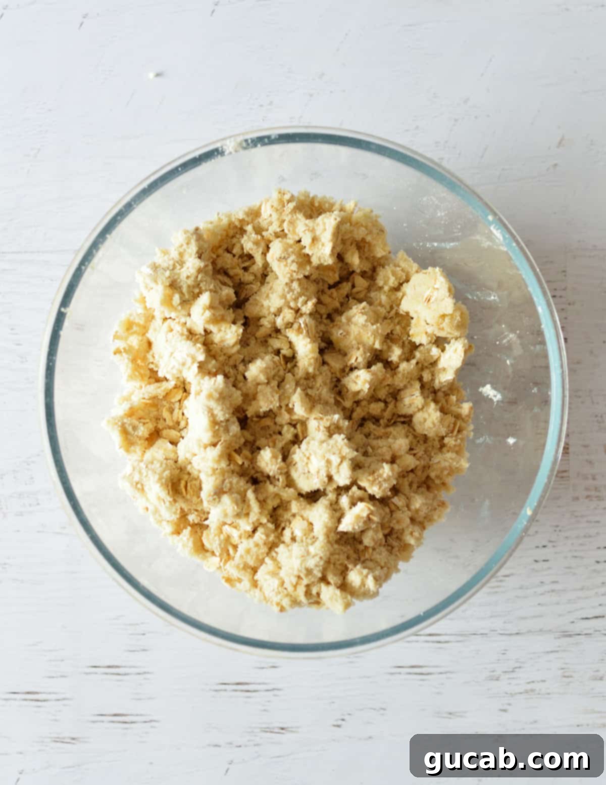 The finished crumb topping mixture in a bowl, showing the perfect texture with small clumps.