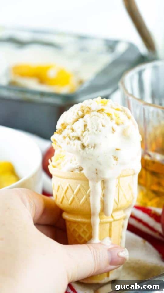 an ice cream cone with peach ice cream. 