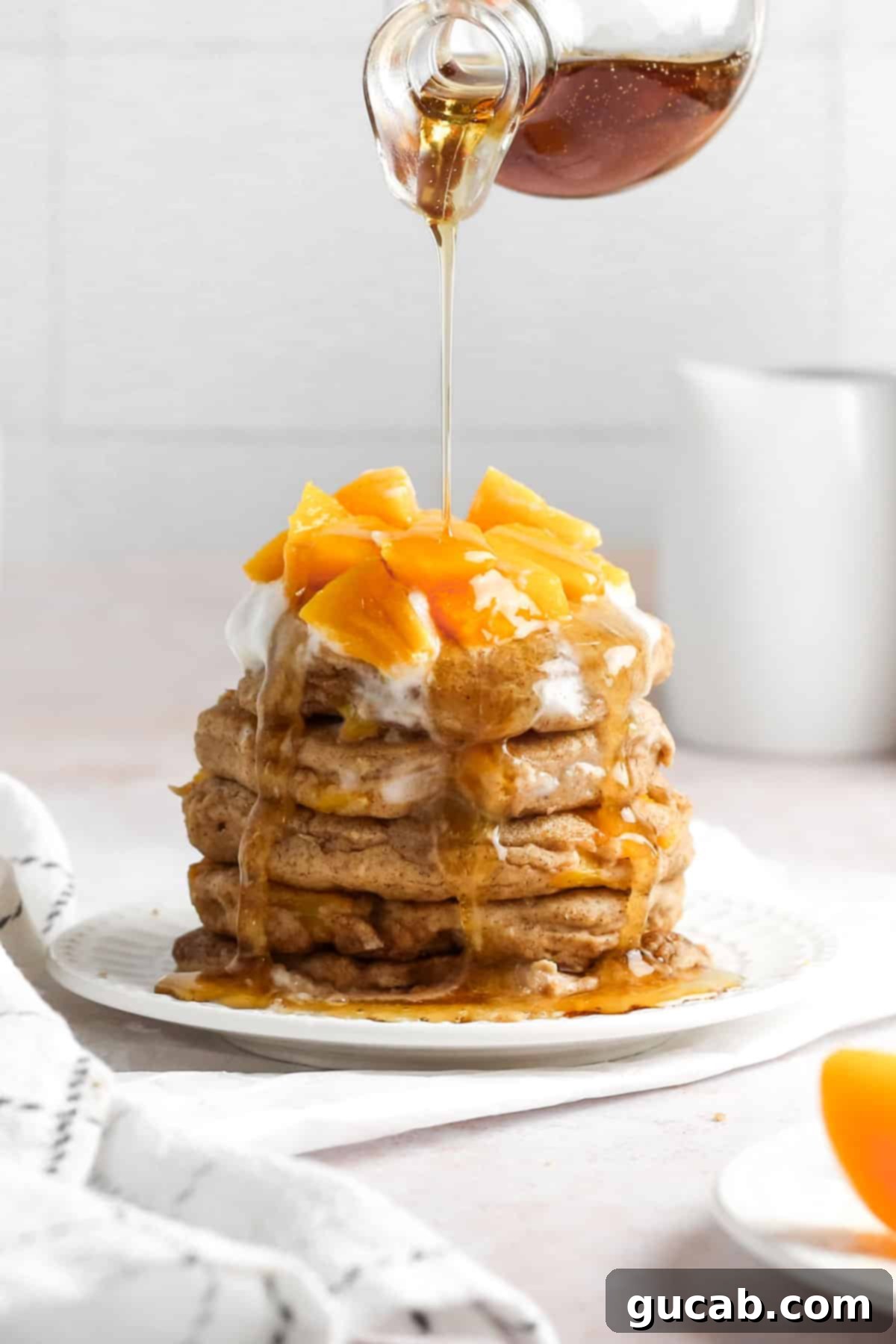 pancakes with peaches and syrup. 