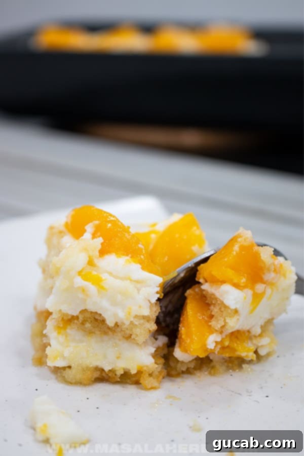 fork cutting into peach tiramisu. 