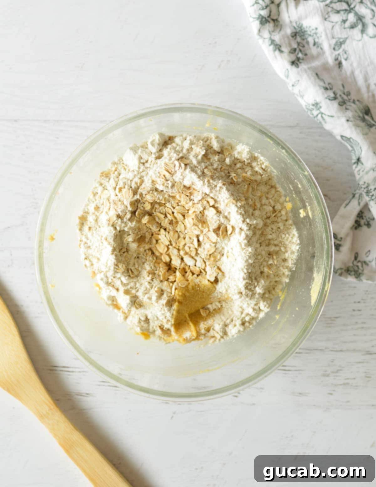 Soft and Chewy Oatmeal Bliss 8 oats and flour on creamed butter in a bowl before mixing