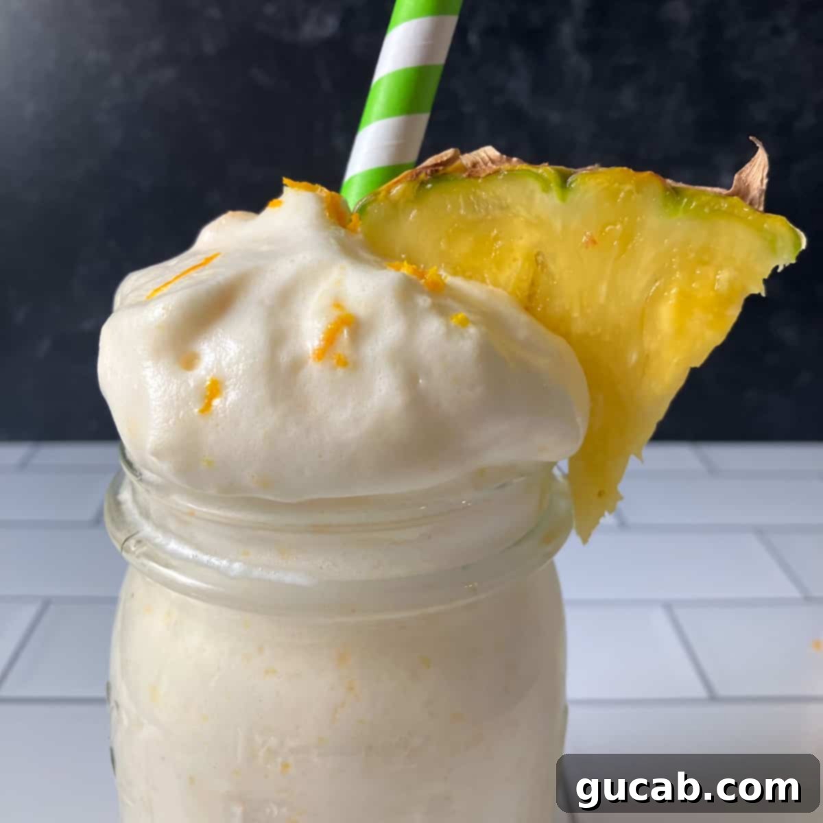 Sweet Chill: 15 Irresistible Frozen Peach Recipes 12 a peach pineapple smoothie with whipped cream and pineapple.