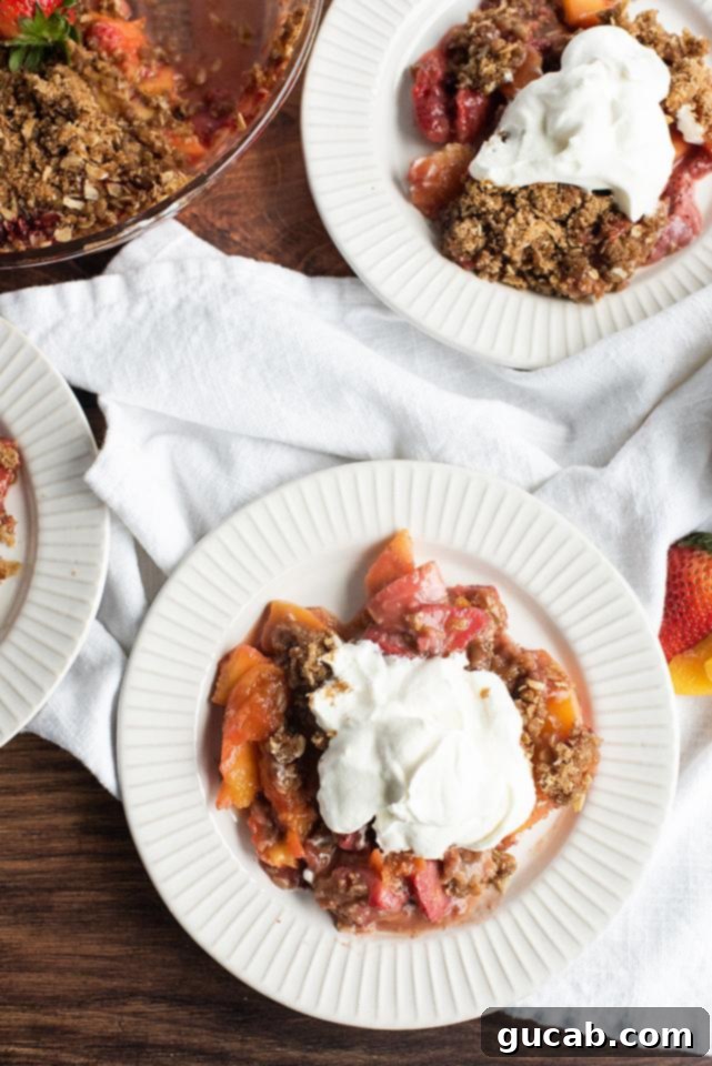 Sweet Chill: 15 Irresistible Frozen Peach Recipes 13 two plates of strawberry peach crisp with whipped cream.