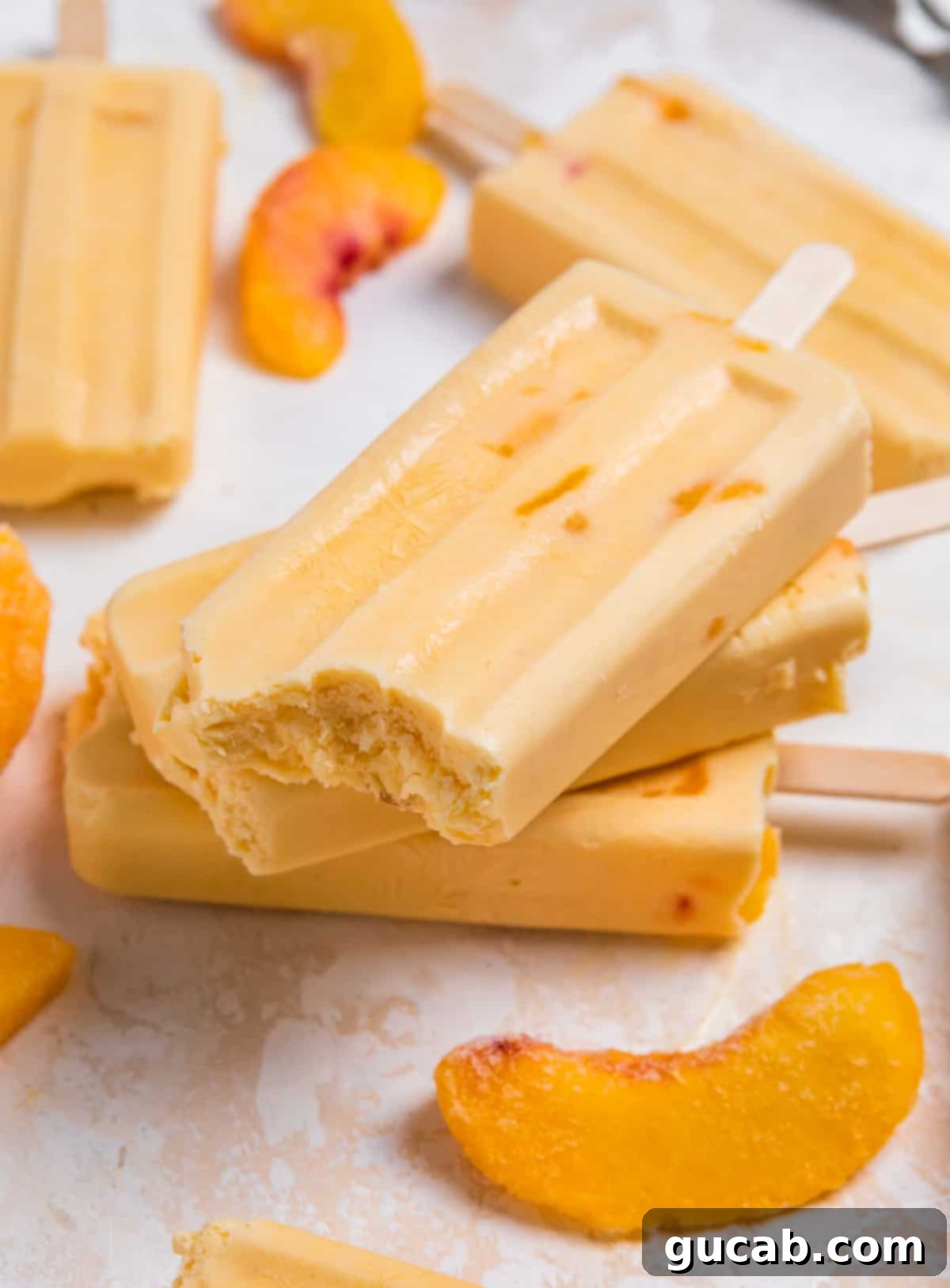 Sweet Chill: 15 Irresistible Frozen Peach Recipes 7 a stack of peach popsicles.