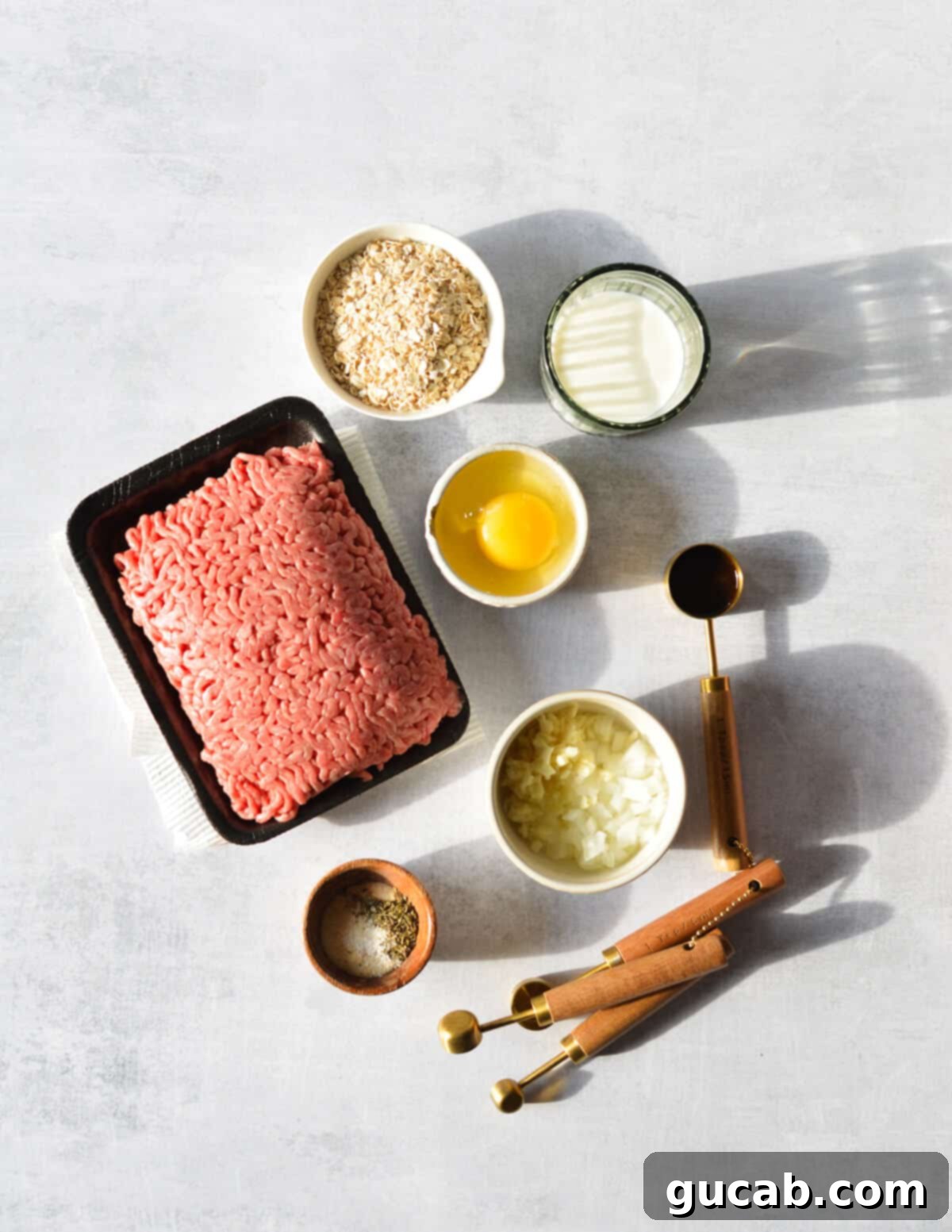 ground beef, egg, onion, garlic, oats, milk, and spices. 