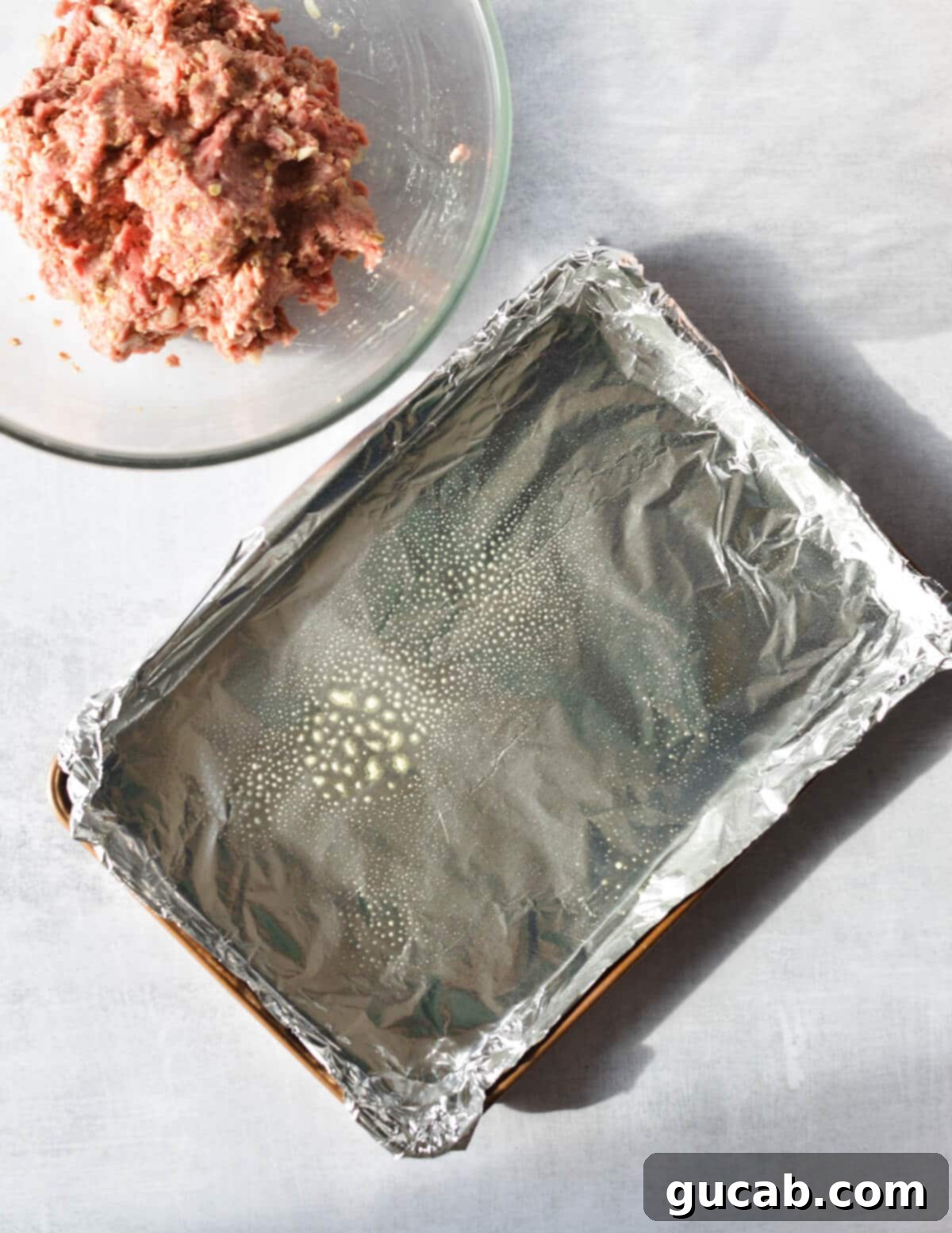 sheet pan with aluminum foil and cooking spray on it.