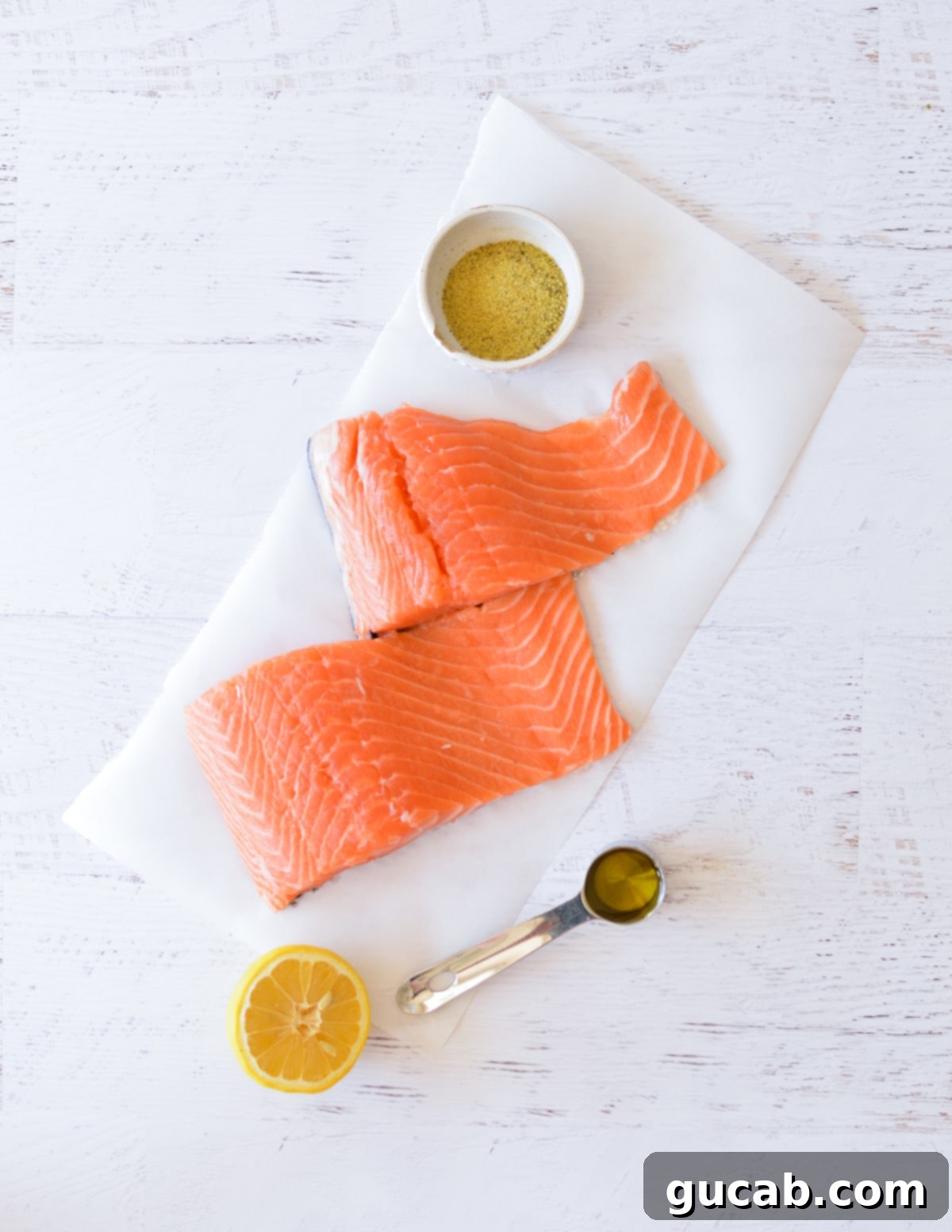 lemon pepper seasoning, salmon fillets, olive oil, and lemon 