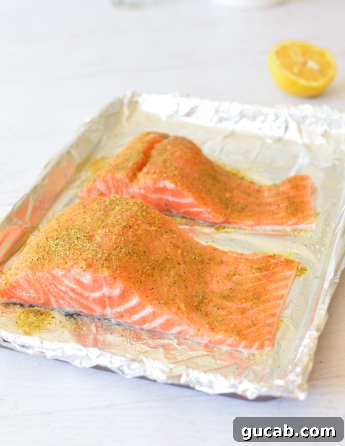 salmon fillets with lemon pepper seasoning on them. 