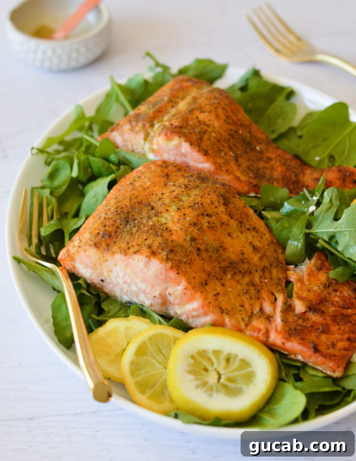 salmon on greens with a lemon. 