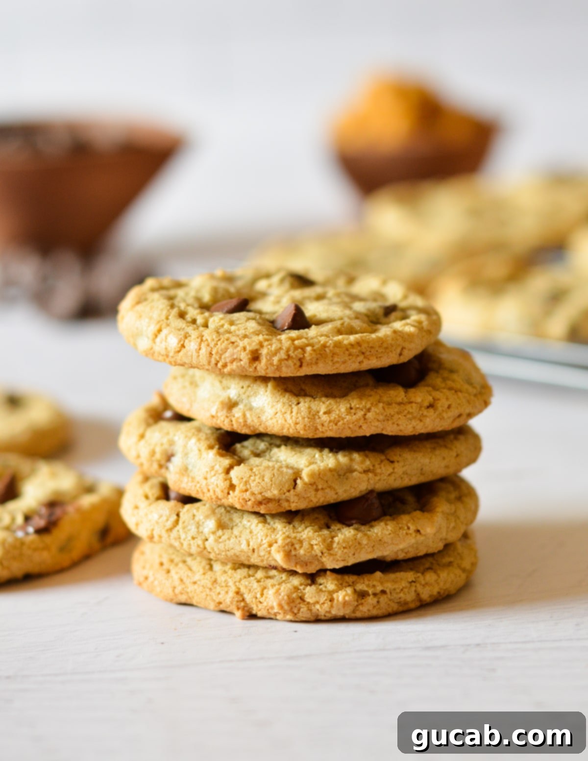 A beautiful stack of five golden oat flour chocolate chip cookies, showcasing their inviting texture.