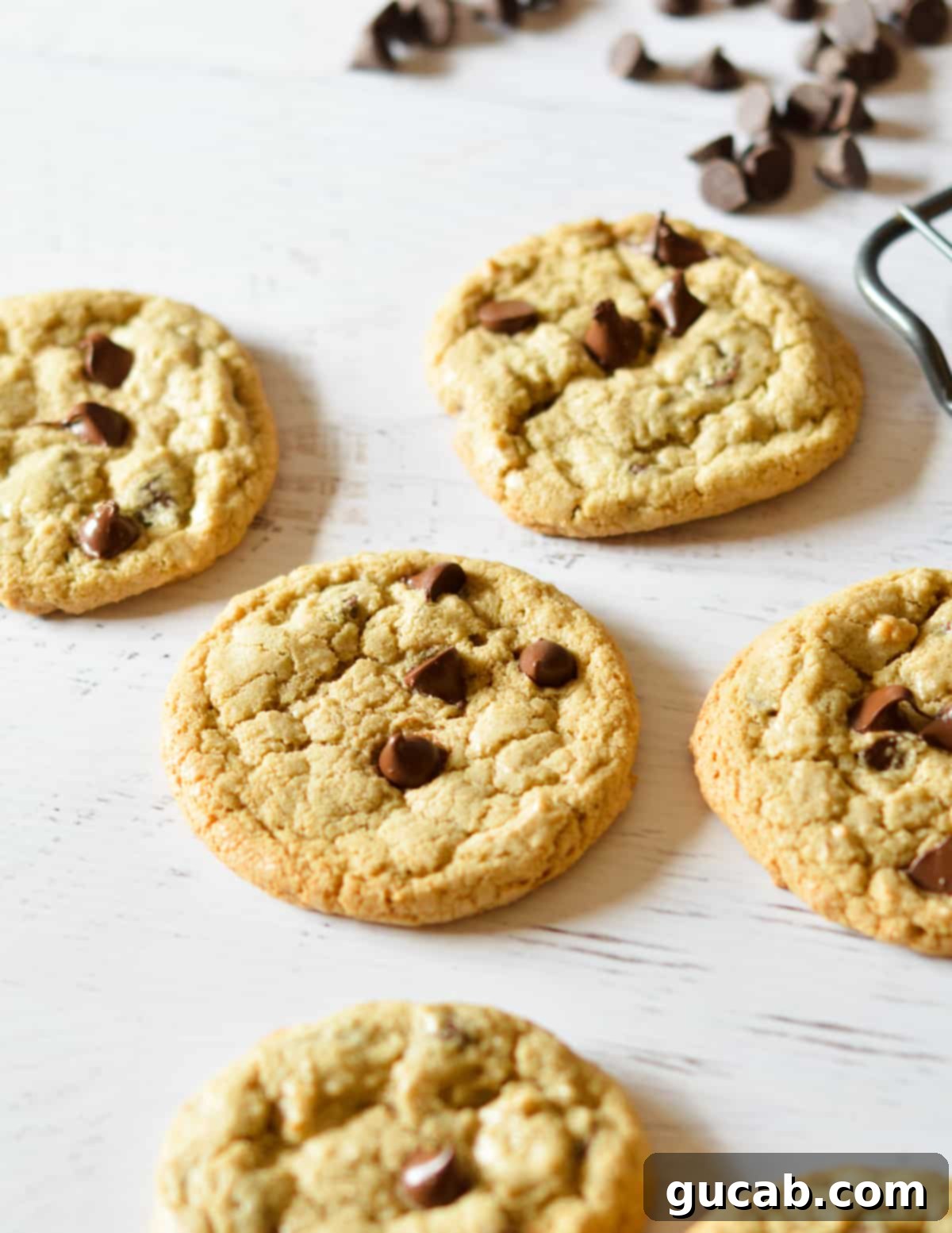 A close-up shot of a stack of freshly baked oat flour chocolate chip cookies, showing their texture and melted chocolate.