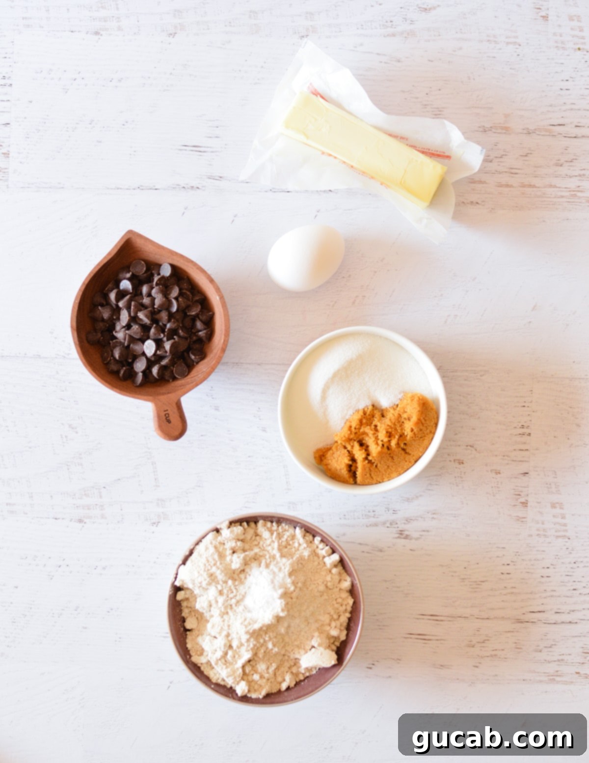 Ingredients laid out: unsalted butter, granulated sugar, brown sugar, large egg, oat flour, and semi-sweet chocolate chips.
