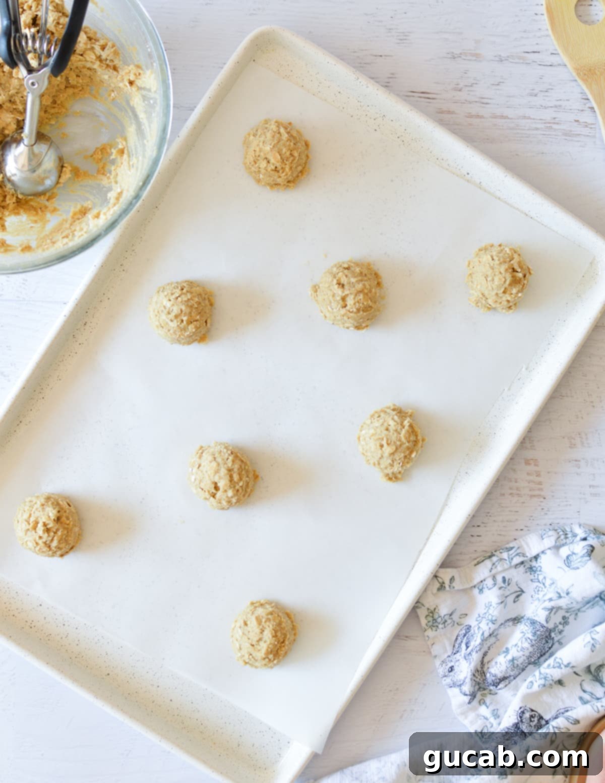 oatmeal cookie dough balls on sheet pan. 