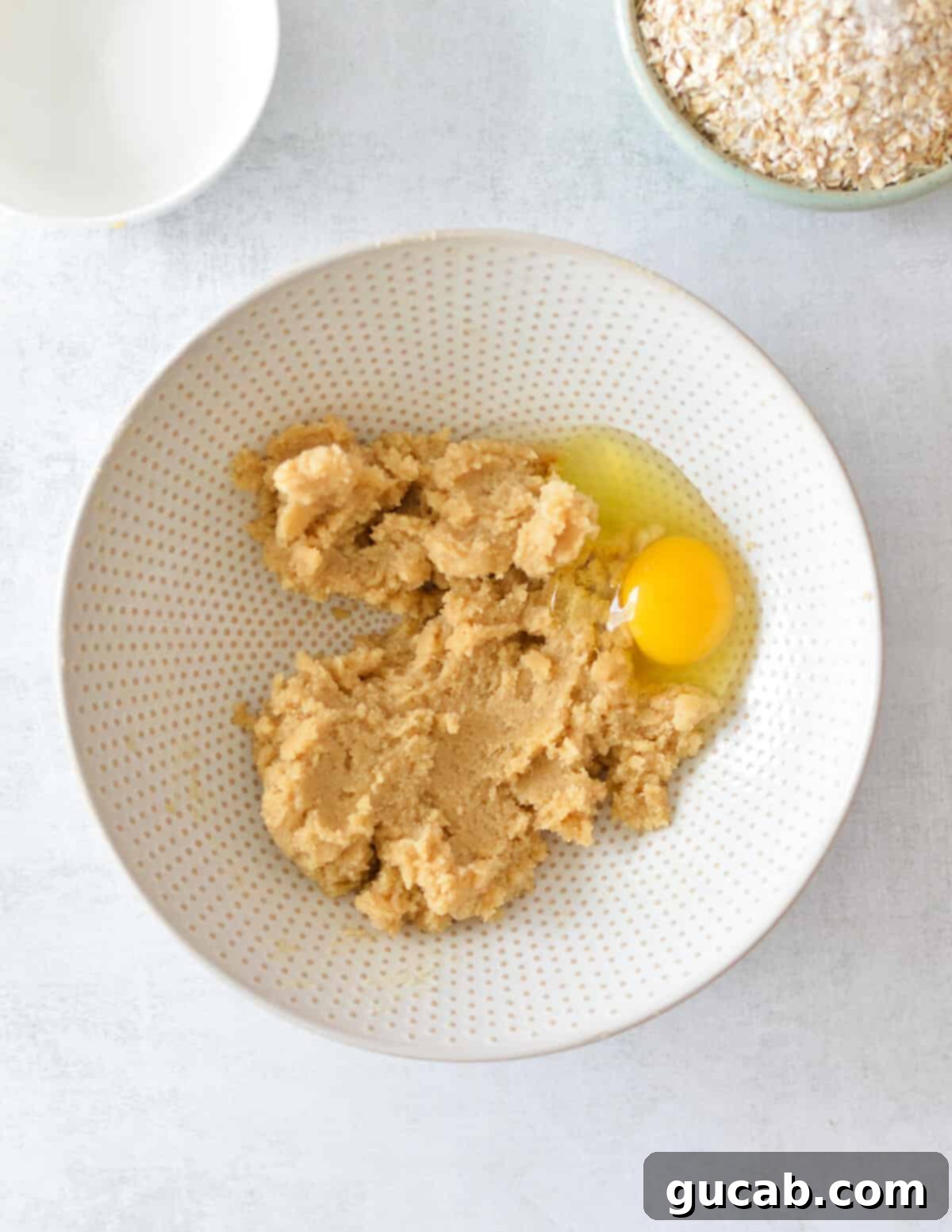 Gluten-Free Oatmeal Cookies 7 Creamed butter and sugar mixture with a single egg added on top, before mixing.