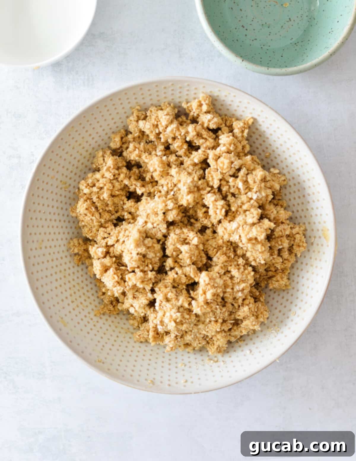 Gluten-Free Oatmeal Cookies 10 A bowl of fully mixed oatmeal cookie dough, rich and ready to be scooped.