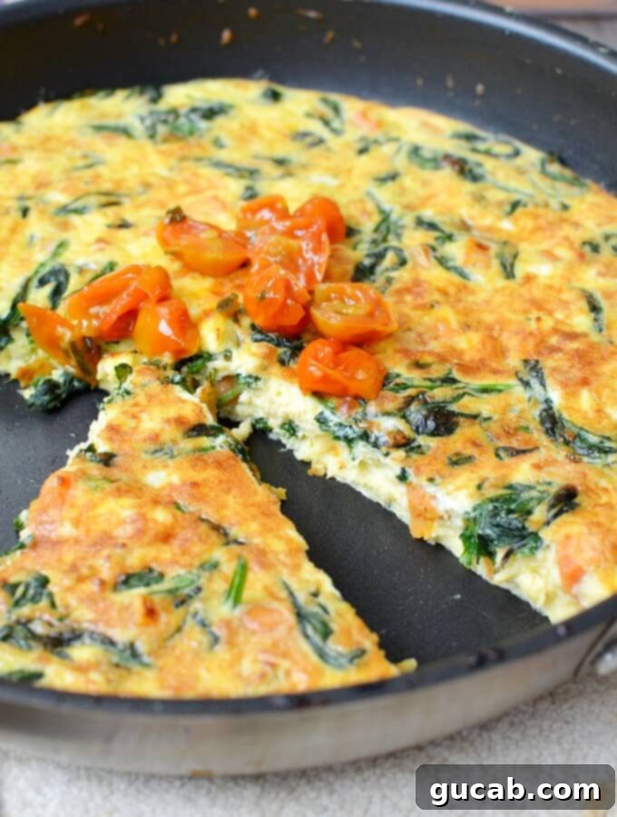 Slice of spinach frittata with golden-brown top and tomato jam