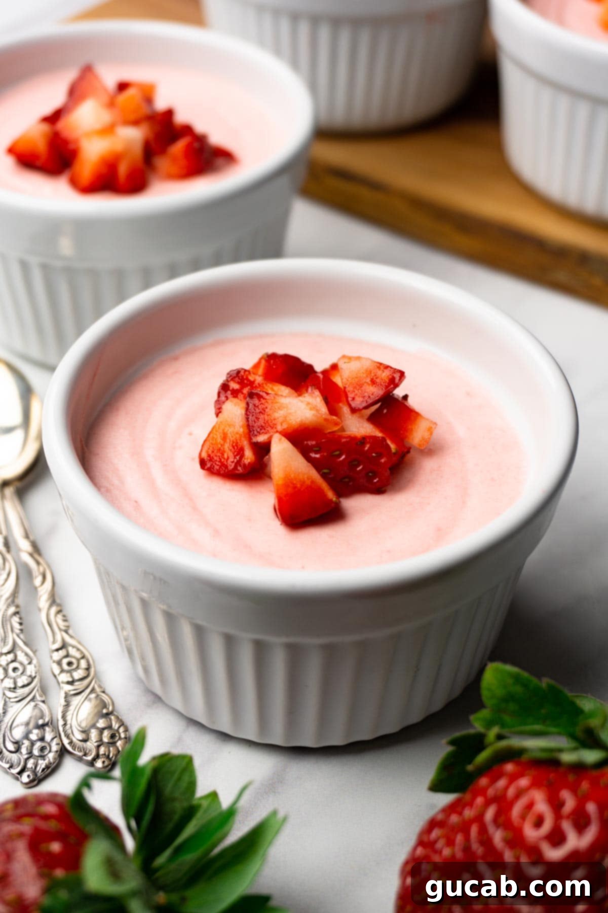 strawberry mousse with diced strawberries on top.