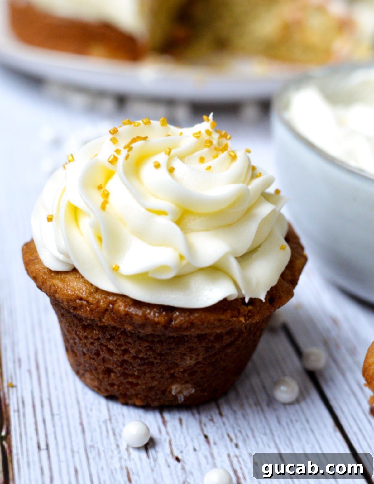A beautifully decorated cupcake topped with the perfect homemade cream cheese frosting.