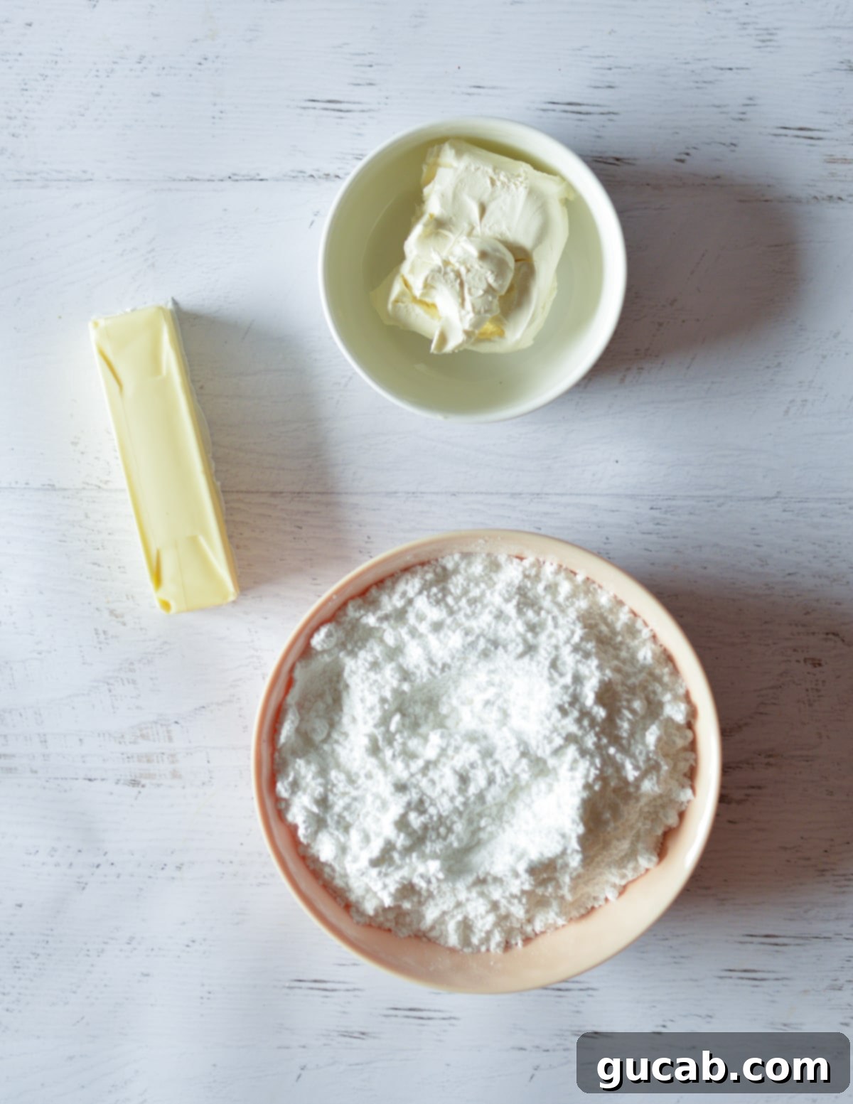Ingredients for cream cheese frosting: cream cheese, butter, powdered sugar, vanilla extract.