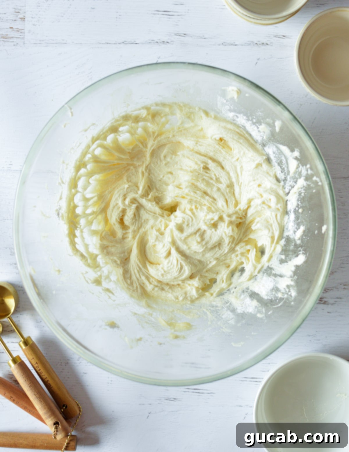 The frosting mixture after the first addition of powdered sugar, already looking smooth.
