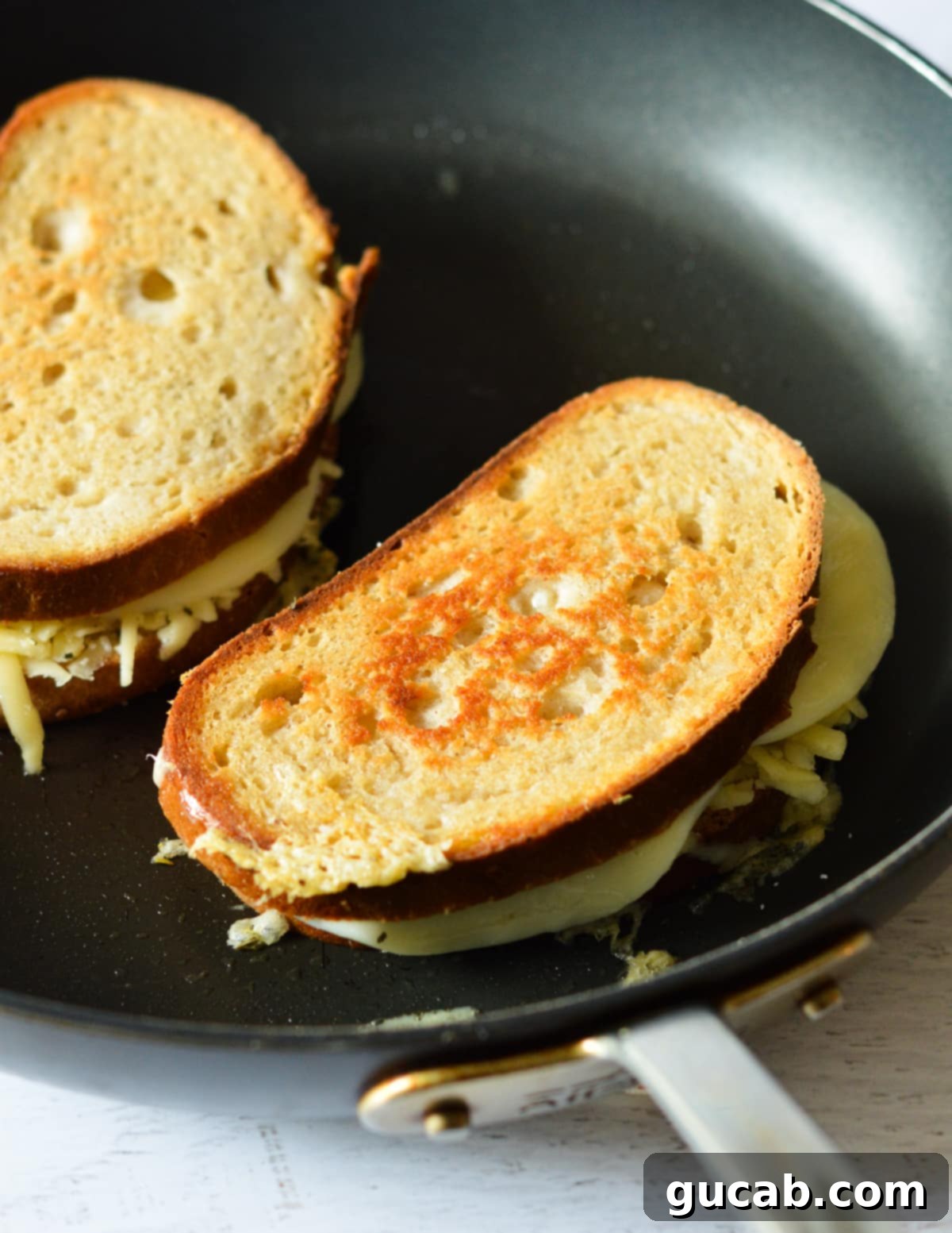 Gourmet Provolone Grilled Cheese 8 grilled cheese sandwiches in a skillet.