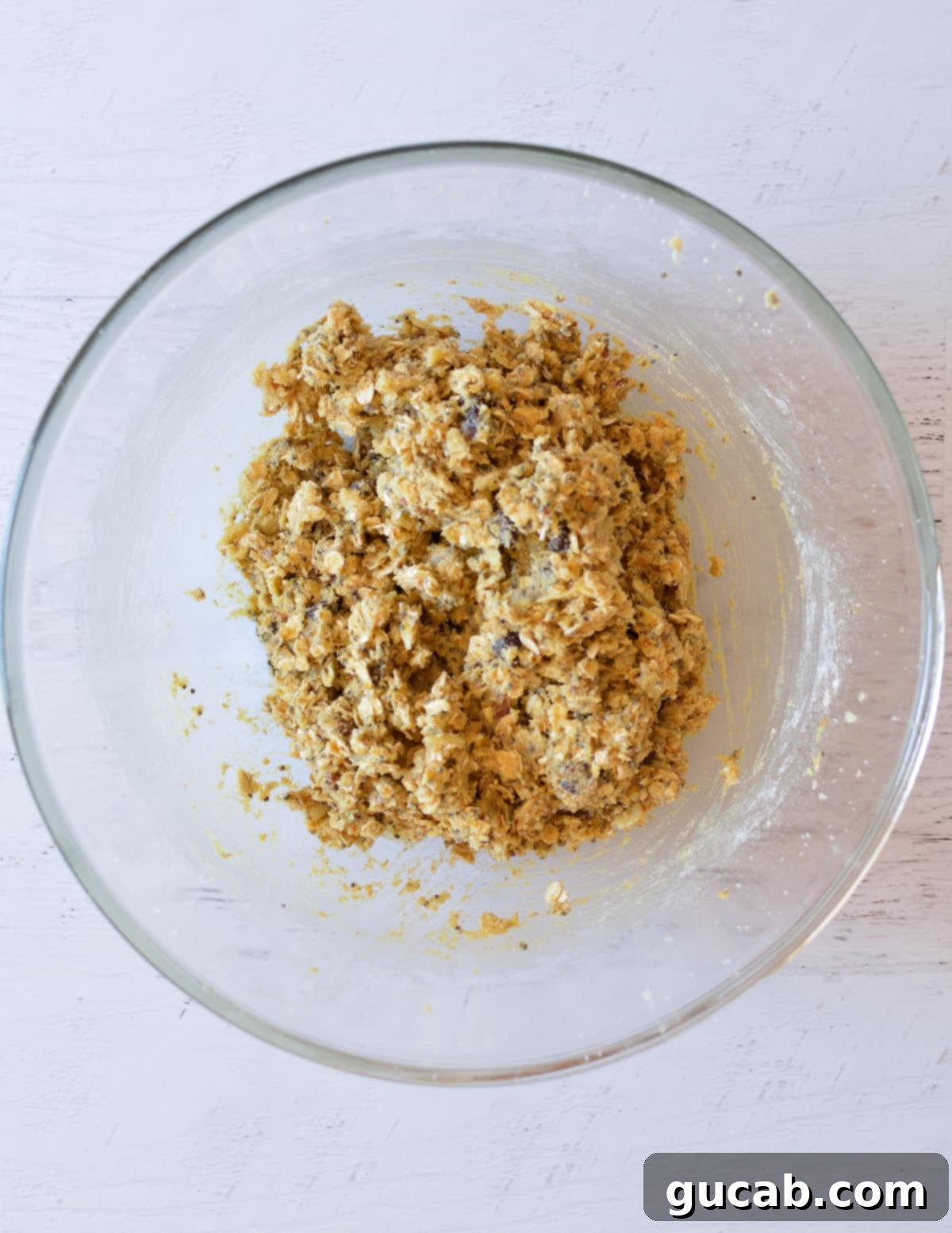 Wholesome Fiber Cookies 11 A bowl filled with freshly prepared high fiber cookie dough, showcasing its rich texture and visible ingredients.