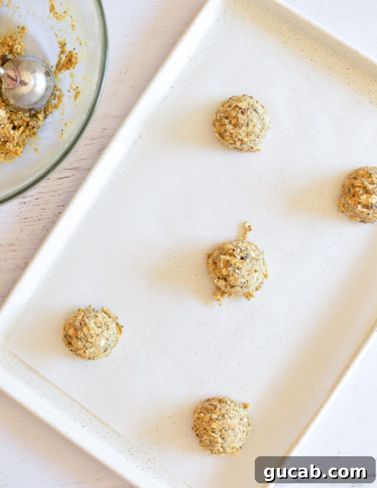 Wholesome Fiber Cookies 12 Uniform cookie dough balls neatly arranged on a parchment-lined sheet pan, spaced for optimal baking.