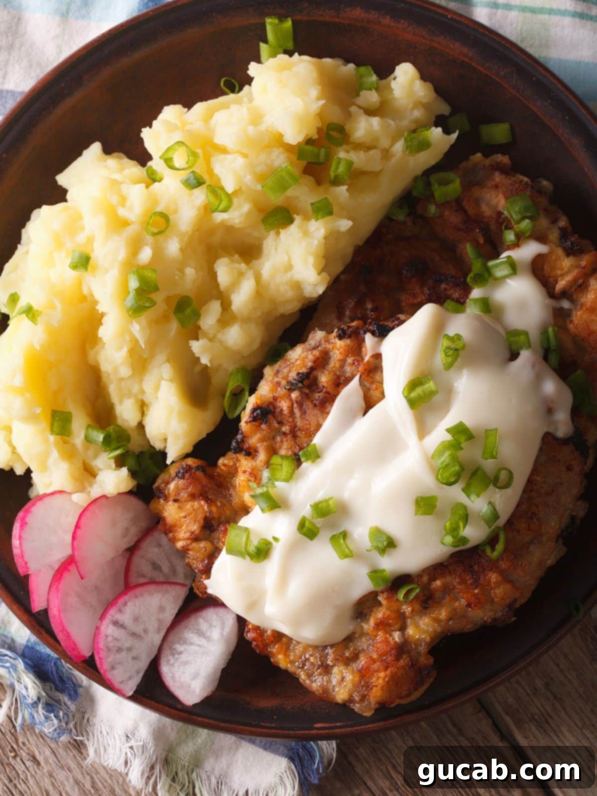 chicken fried steak and mashed potatoes on a plate. 