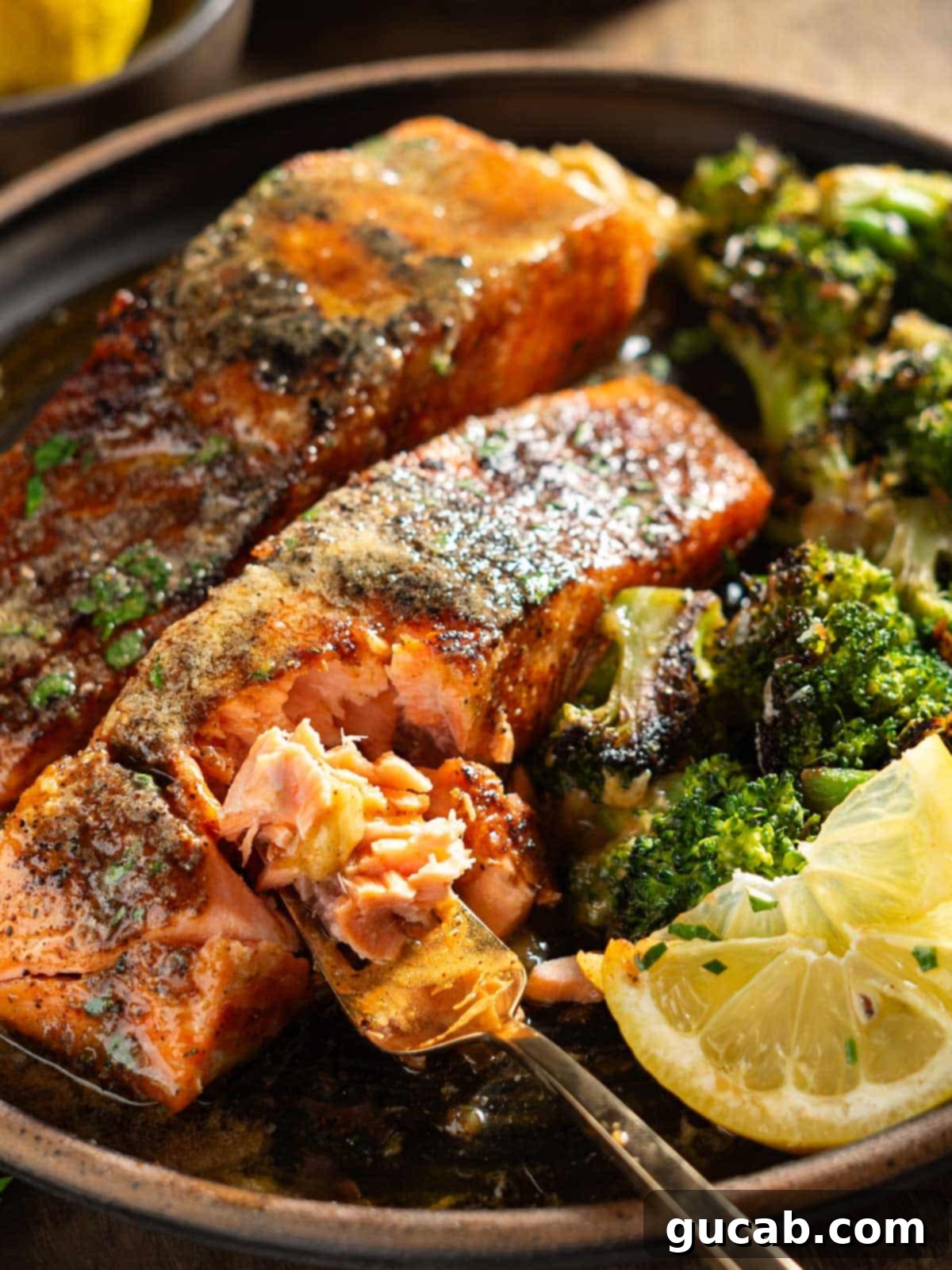 a forkful of salmon with broccoli. 