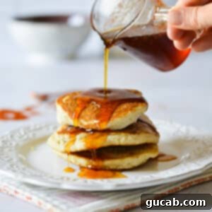 Homemade spicy maple syrup drizzled over a stack of pancakes, showing its rich texture and inviting warmth.